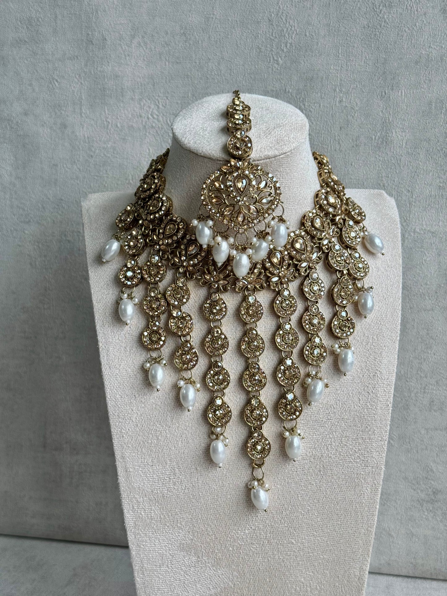 Ayura Designs Sameena Set – Opulent Champagne Gold Adorned with Luminous White Pearls Featuring a Statement Necklace, Tikka, and Chandelier Earrings