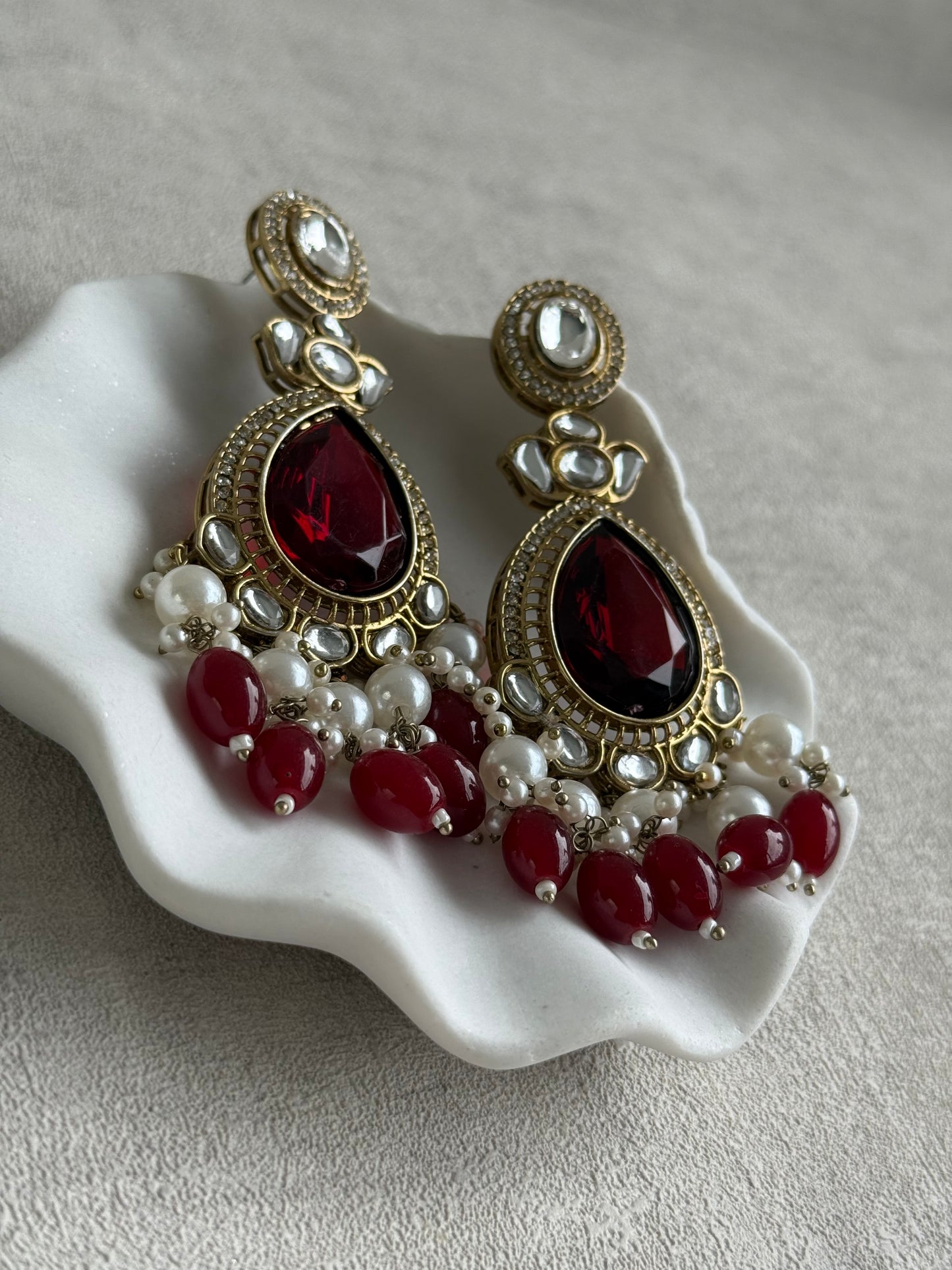 Ayura Designs Nageen Earrings – Antique Gold Jhumkis with Ruby Red Stones, Mirror-Cut Accents & Pearl Drops