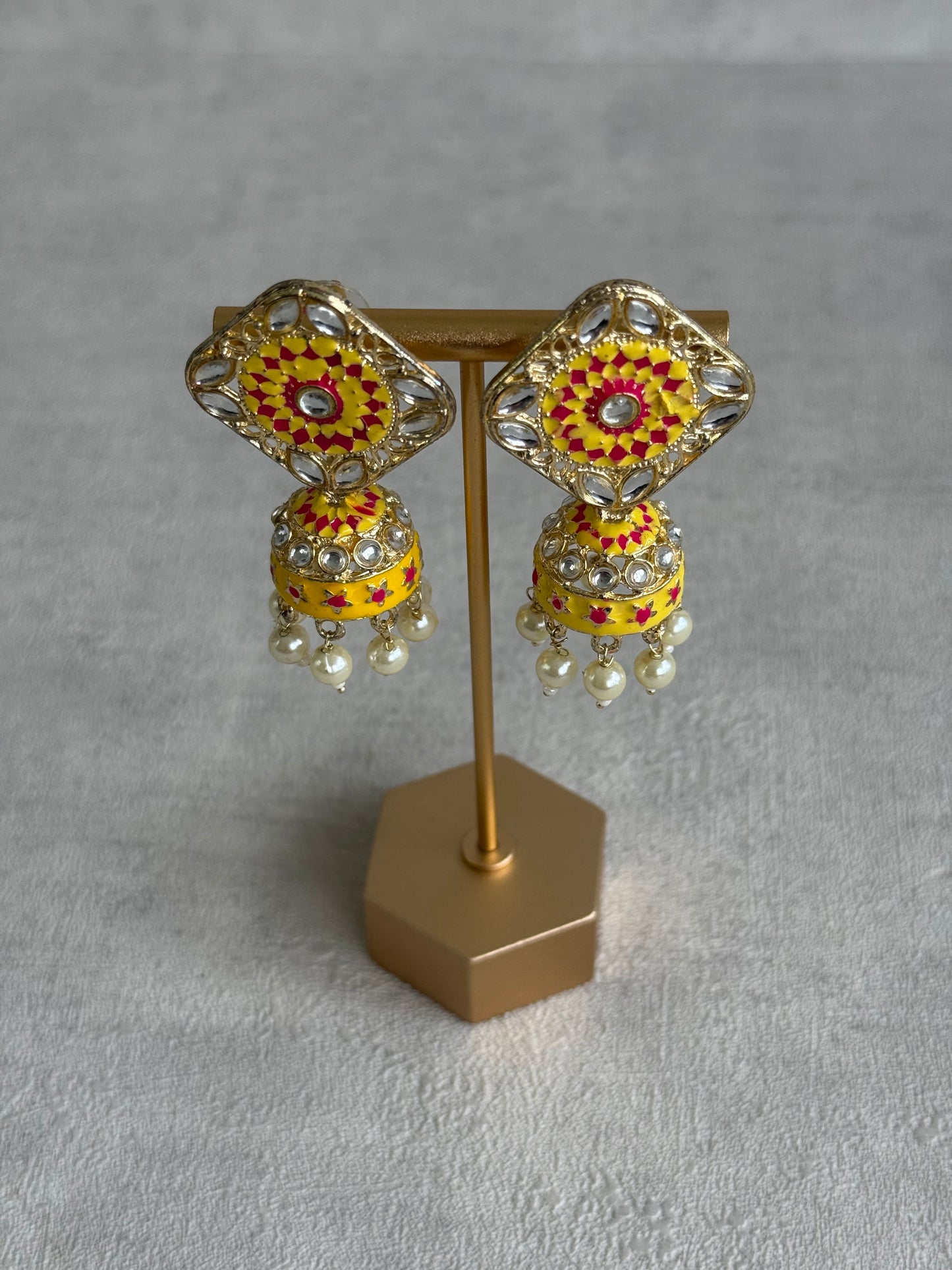Ayura Designs Rangoli Jhumkis – Marigold Yellow & Hot Pink Meenakari with Pearl Drops in Antique Gold Finish