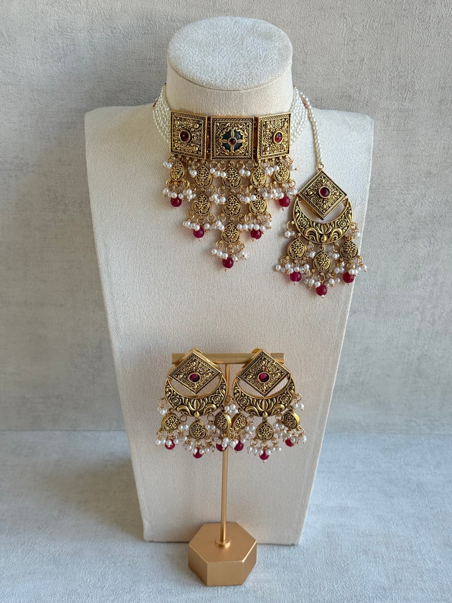 Ayura Designs Samera Choker Set with Earrings & Tikka – Rani Pink Beads, Pearl Detailing, Green Centre Stone, Floral Motifs & Antique Gold Finish