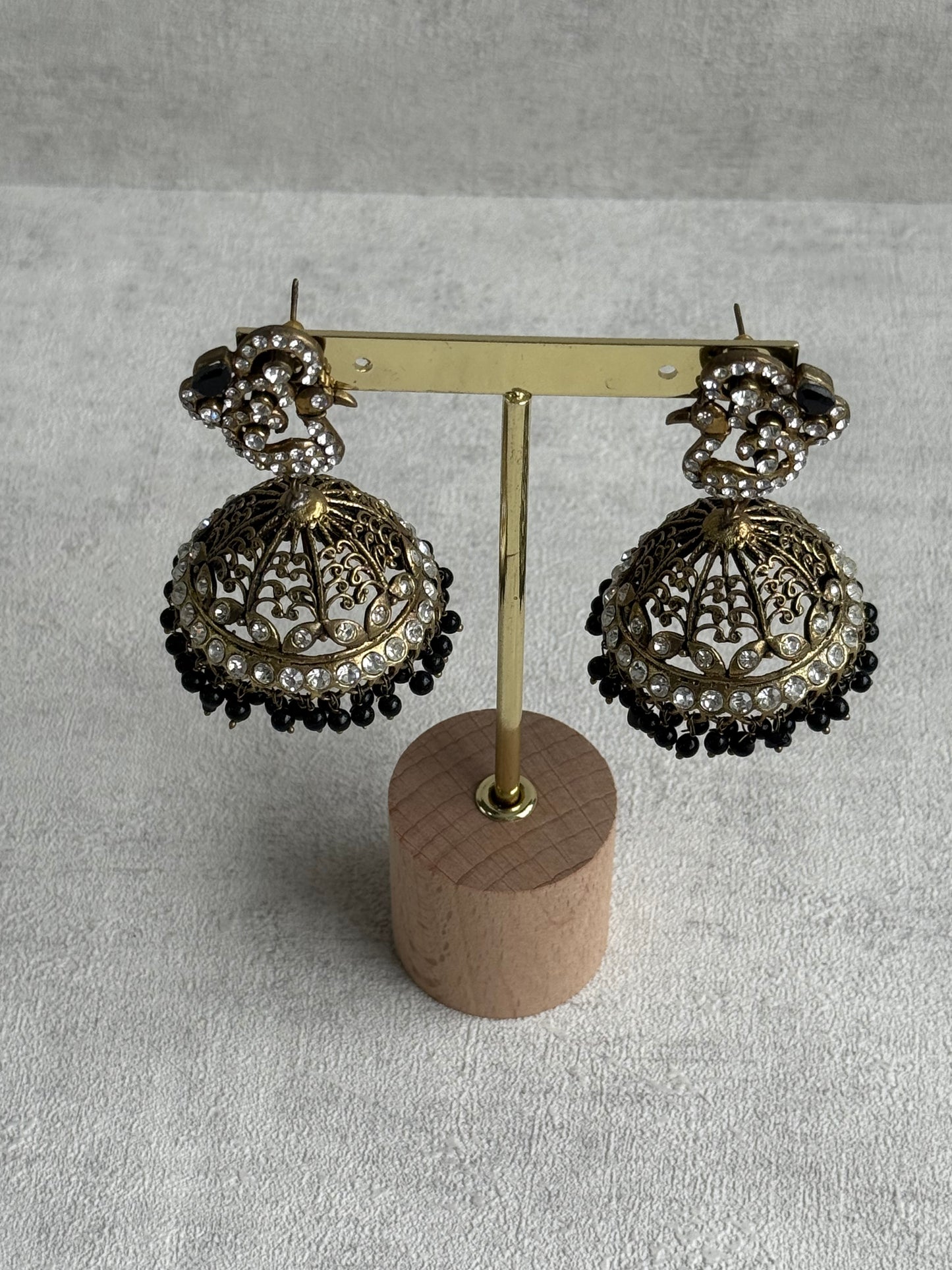 Ayura Designs Mayurika Jhumkis – Antique Gold Jhumkis with Crystal Stones, Black Beads & Peacock Motif