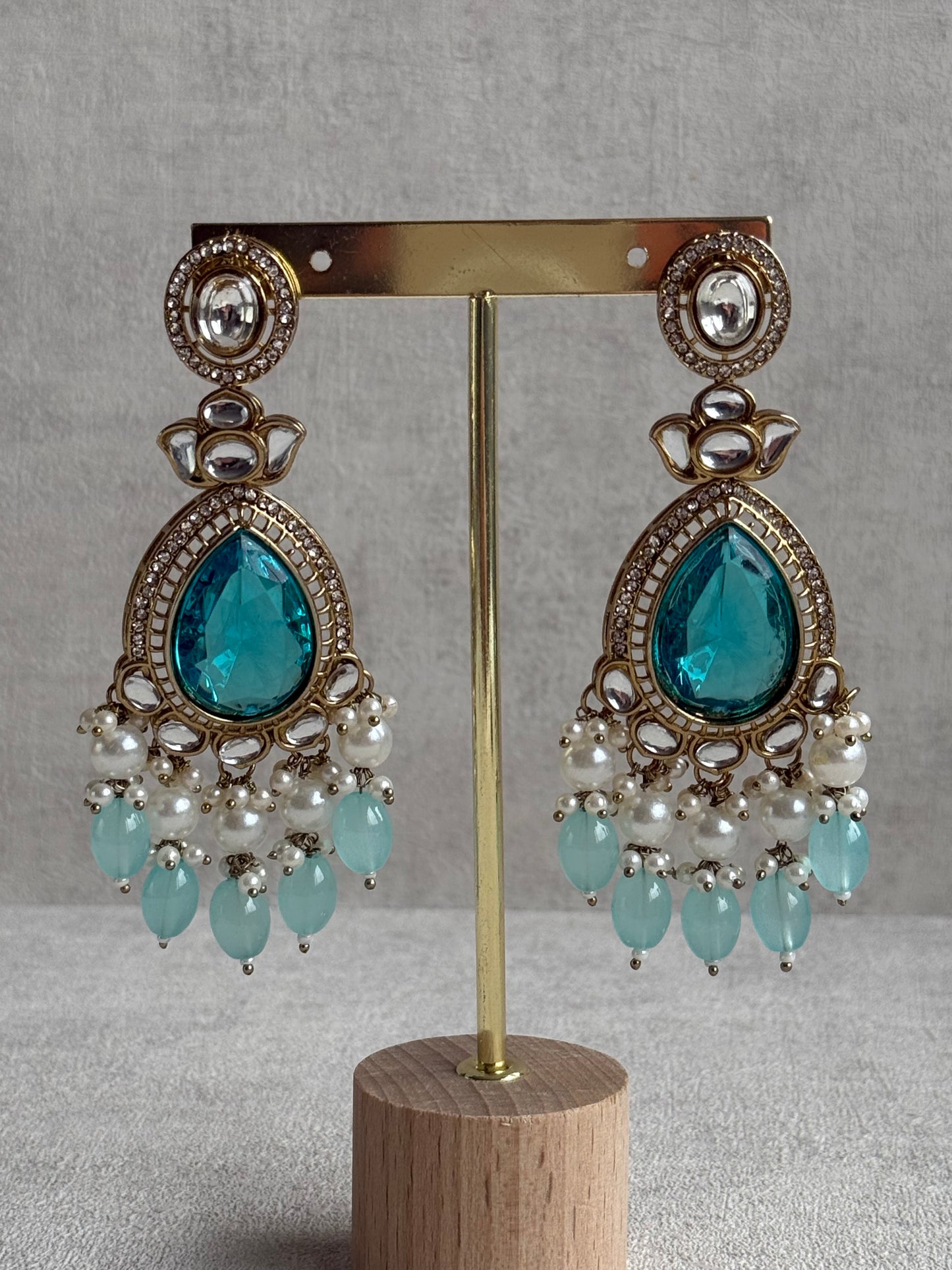 Ayura Designs Nageen Earrings – Antique Gold Jhumkis with Aqua Blue Stones, Mirror-Cut Accents & Pearl Drops