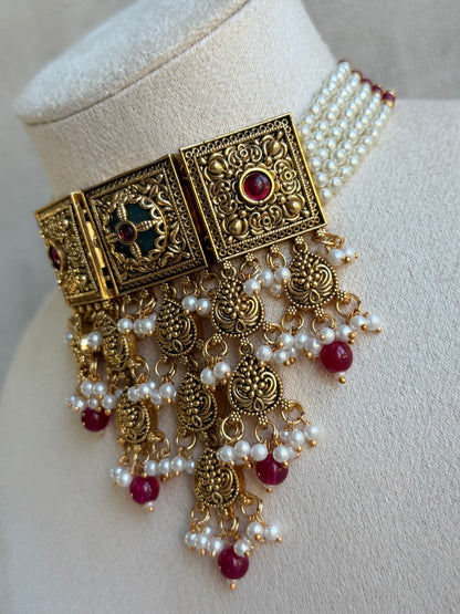 Ayura Designs Samera Choker Set with Earrings & Tikka – Rani Pink Beads, Pearl Detailing, Green Centre Stone, Floral Motifs & Antique Gold Finish