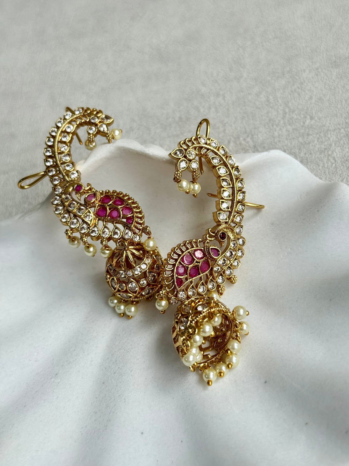 Ayura Designs Padma Earrings – Gold Half Ear Cuffs with Peacock Motif, Pink Stone Accents, Kundan Crystals & Pearl Jhumka Drops