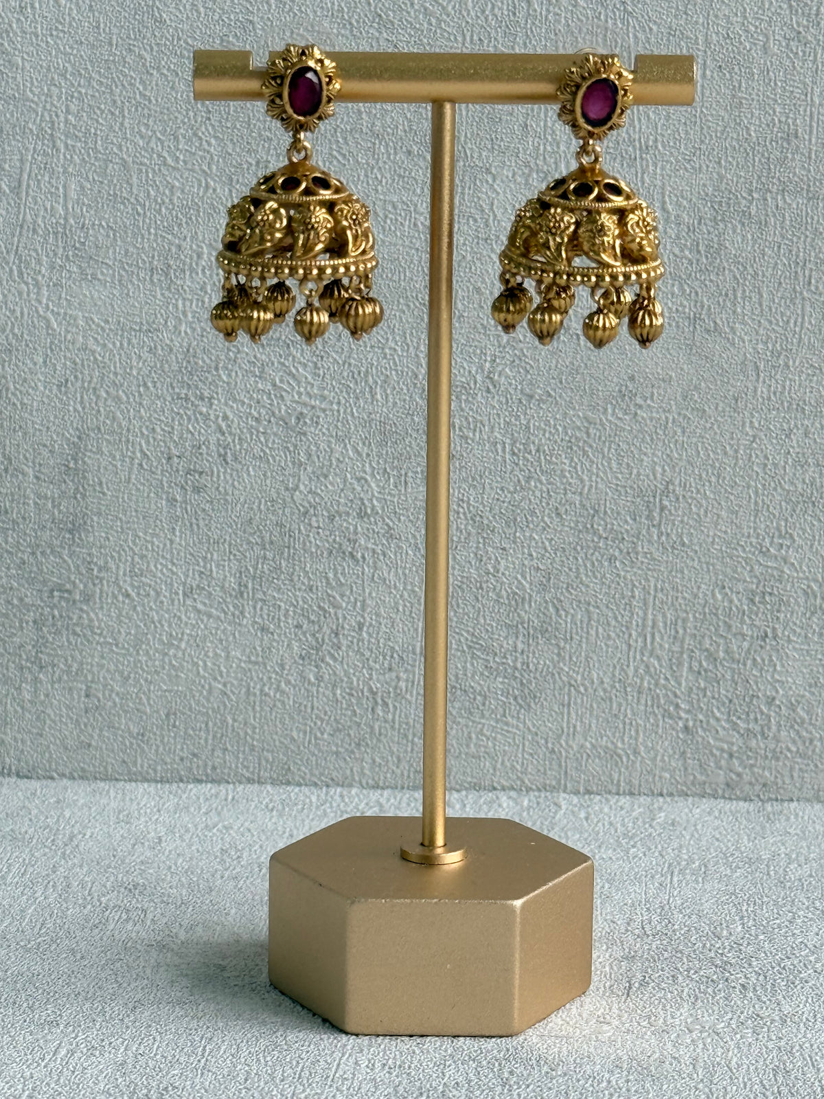 Ayura Designs Savya Jhumkis – Rani Pink Stones, Floral Motifs & Antique Gold Finish