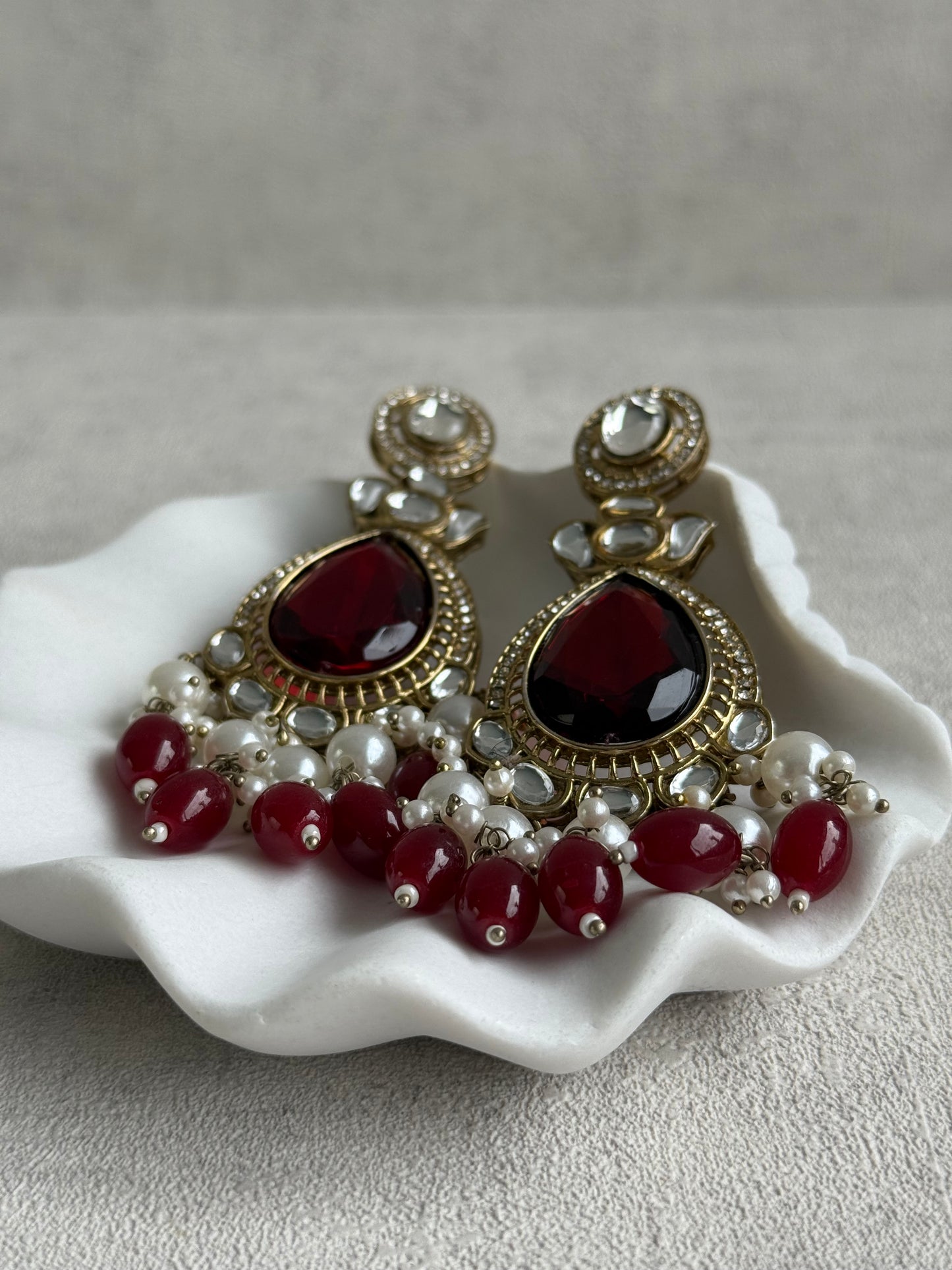 Ayura Designs Nageen Earrings – Antique Gold Jhumkis with Ruby Red Stones, Mirror-Cut Accents & Pearl Drops