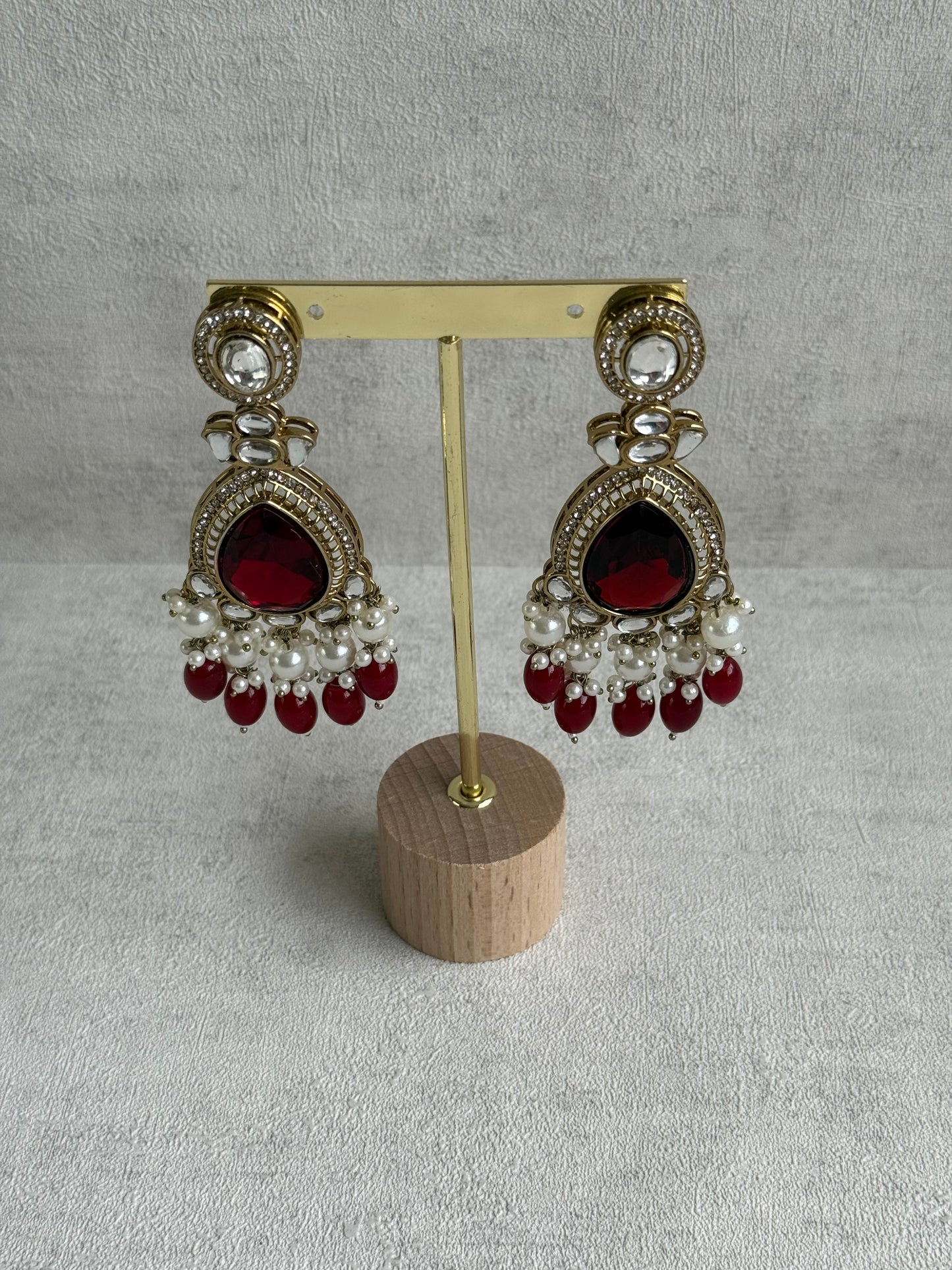 Ayura Designs Nageen Earrings – Antique Gold Jhumkis with Ruby Red Stones, Mirror-Cut Accents & Pearl Drops