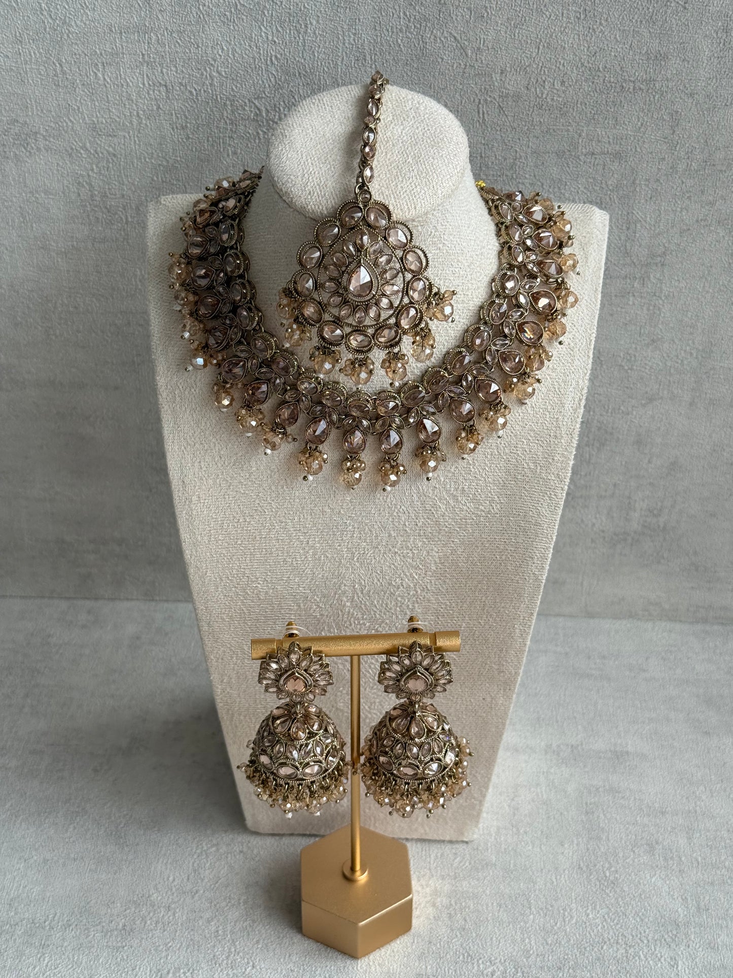 Ayura Designs Emaan Set with Jhumkis & Tikka – Champagne Stones, Antique Gold Finish & Crystal Detailing