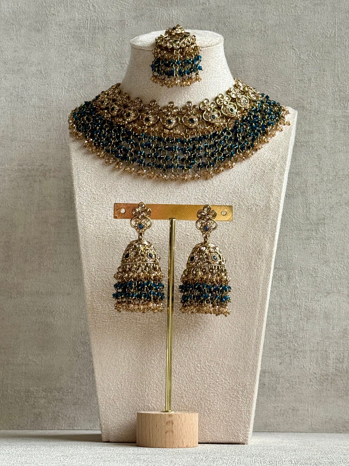 Ayura Designs Mahreen Set – Necklace, Jhumkis & Tikka with Mirror-Cut Stones, Peacock Blue Beads & Gold Finish