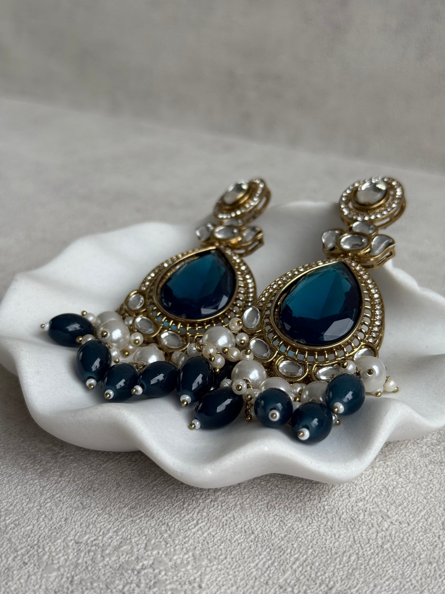 Ayura Designs Nageen Earrings – Antique Gold Jhumkis with Ink Blue Stones, Mirror-Cut Detailing & Pearl Drops