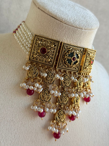 Ayura Designs Samera Choker Set with Earrings & Tikka – Rani Pink Beads, Pearl Detailing, Green Centre Stone, Floral Motifs & Antique Gold Finish