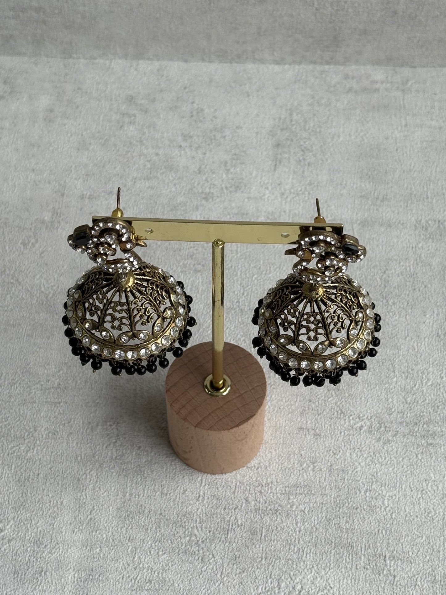 Ayura Designs Mayurika Jhumkis – Antique Gold Jhumkis with Crystal Stones, Black Beads & Peacock Motif