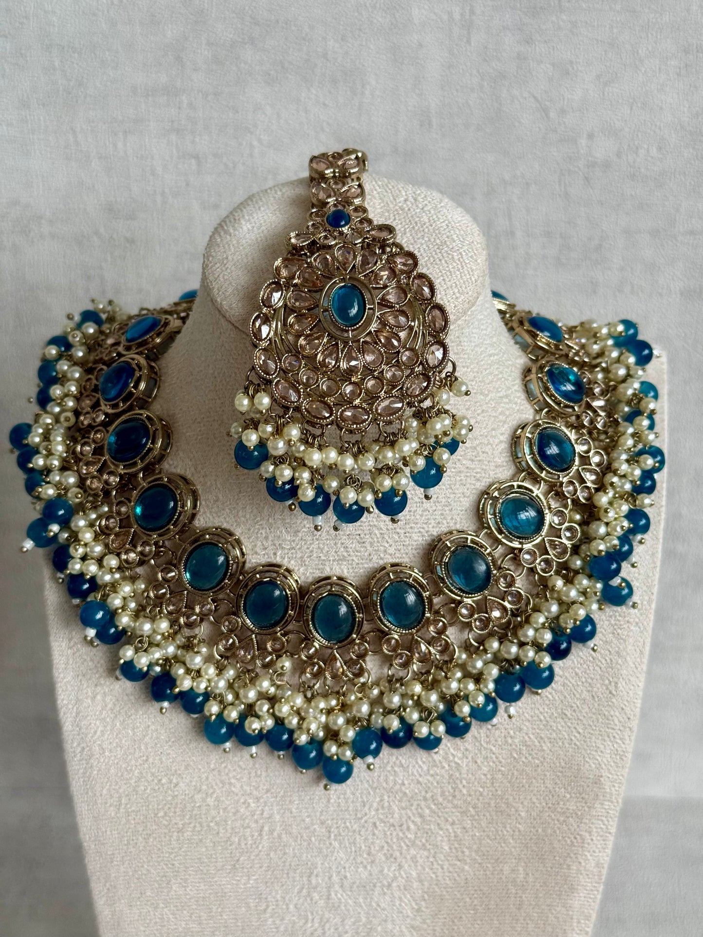 Ayura Designs Zubi Set with Jhumkis & Tikka – Deep Blue Stones, Pearl Detailing & Antique Gold Finish