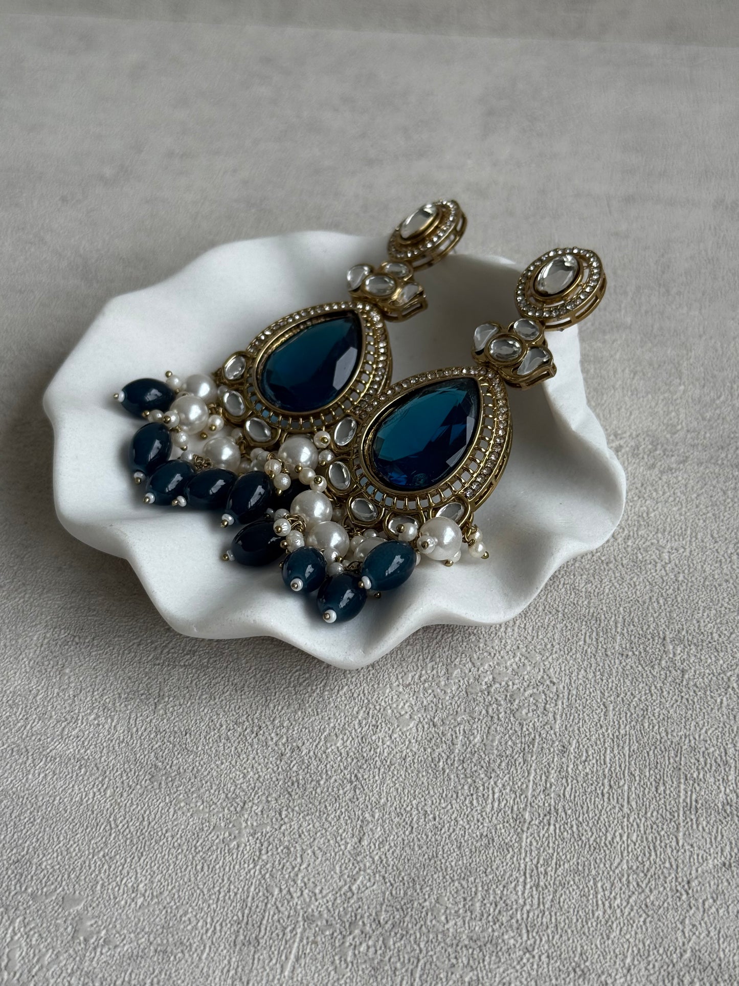 Ayura Designs Nageen Earrings – Antique Gold Jhumkis with Ink Blue Stones, Mirror-Cut Detailing & Pearl Drops