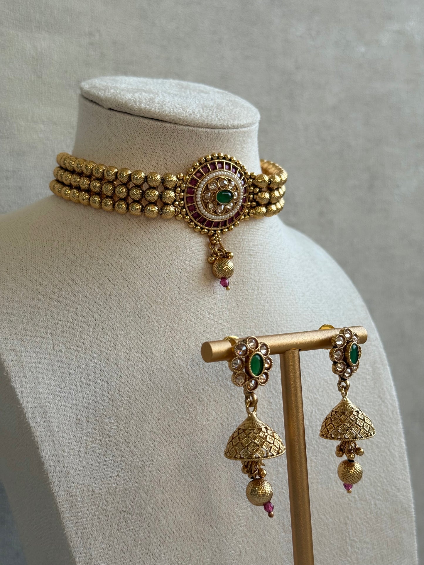 Ayura Designs Kavish Choker Set – Antique Gold Choker with Jhumkis in Rani Pink & Emerald Green with Pearl Detailing