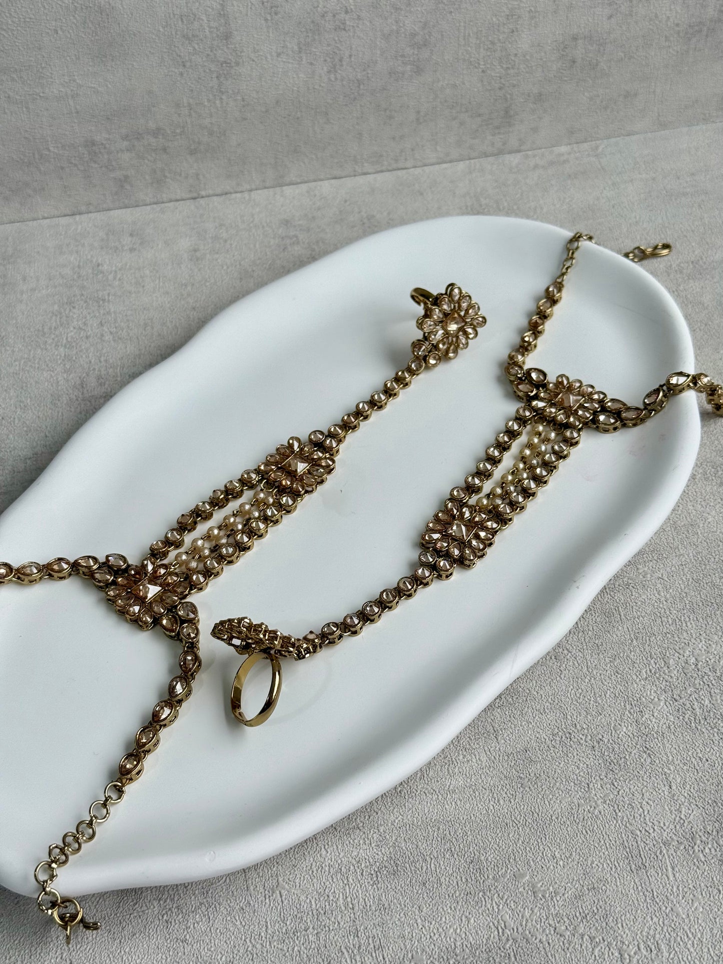 Ayura Designs Rupi Haathphool – Antique Gold with Champagne Stones & Pearl Detailing