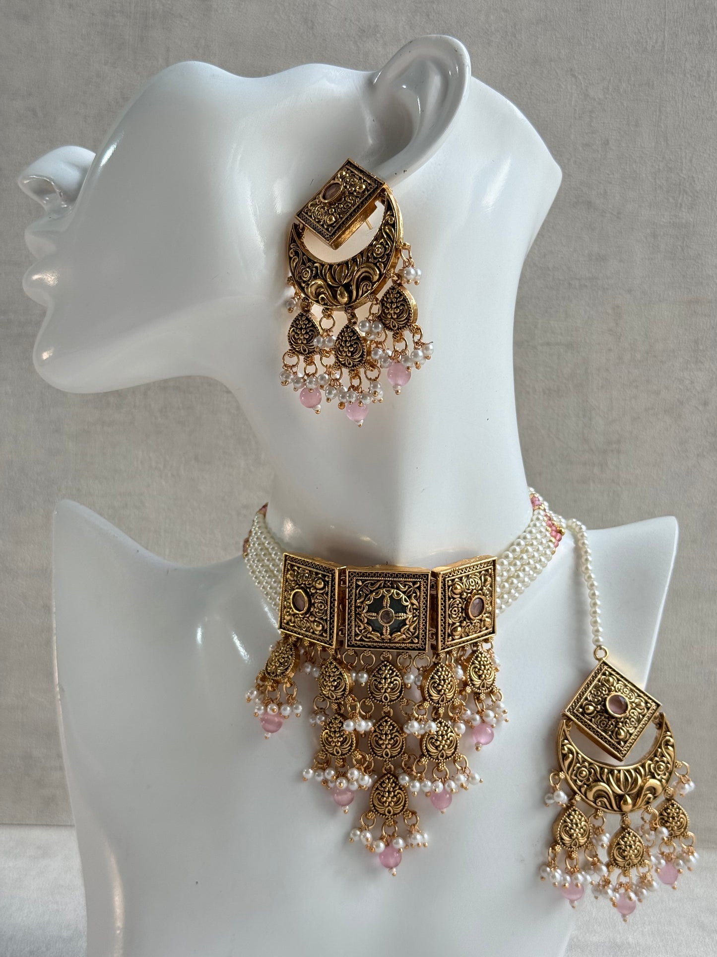 Ayura Designs Samera Choker Set with Earrings & Tikka – Blush Pink Beads, Pearl Detailing, Green Centre Stone, Floral Motifs & Antique Gold Finish