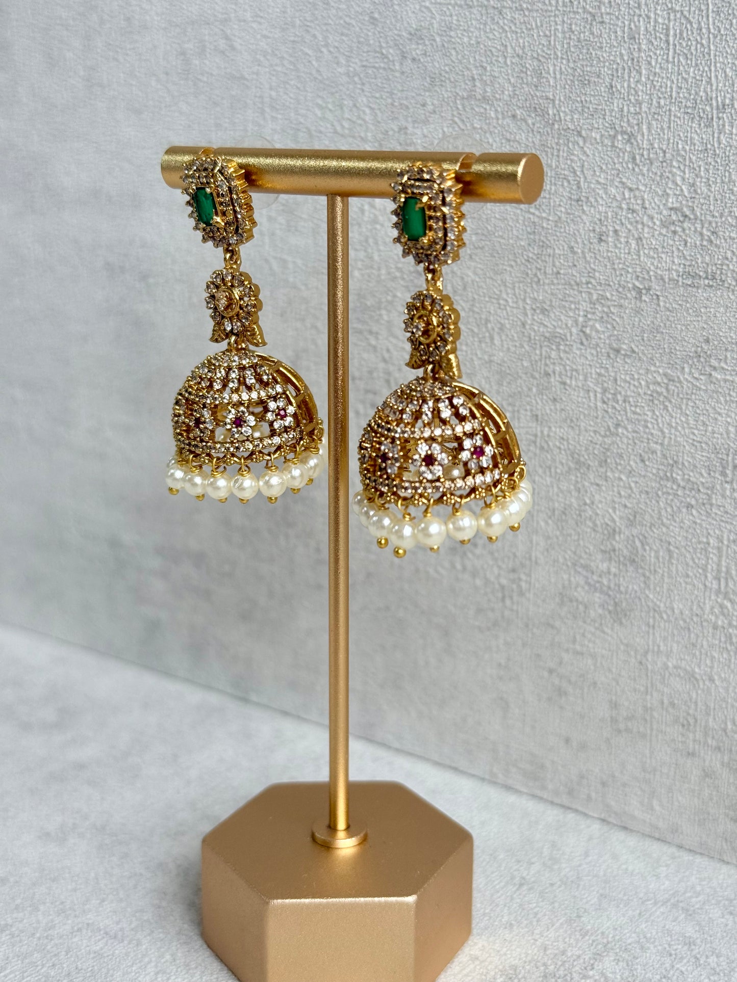 Ayura Designs Maya Jhumkis – Gold Jhumkis with Emerald Green Studs, Pink Stones, Crystal Detailing & Pearl Drops