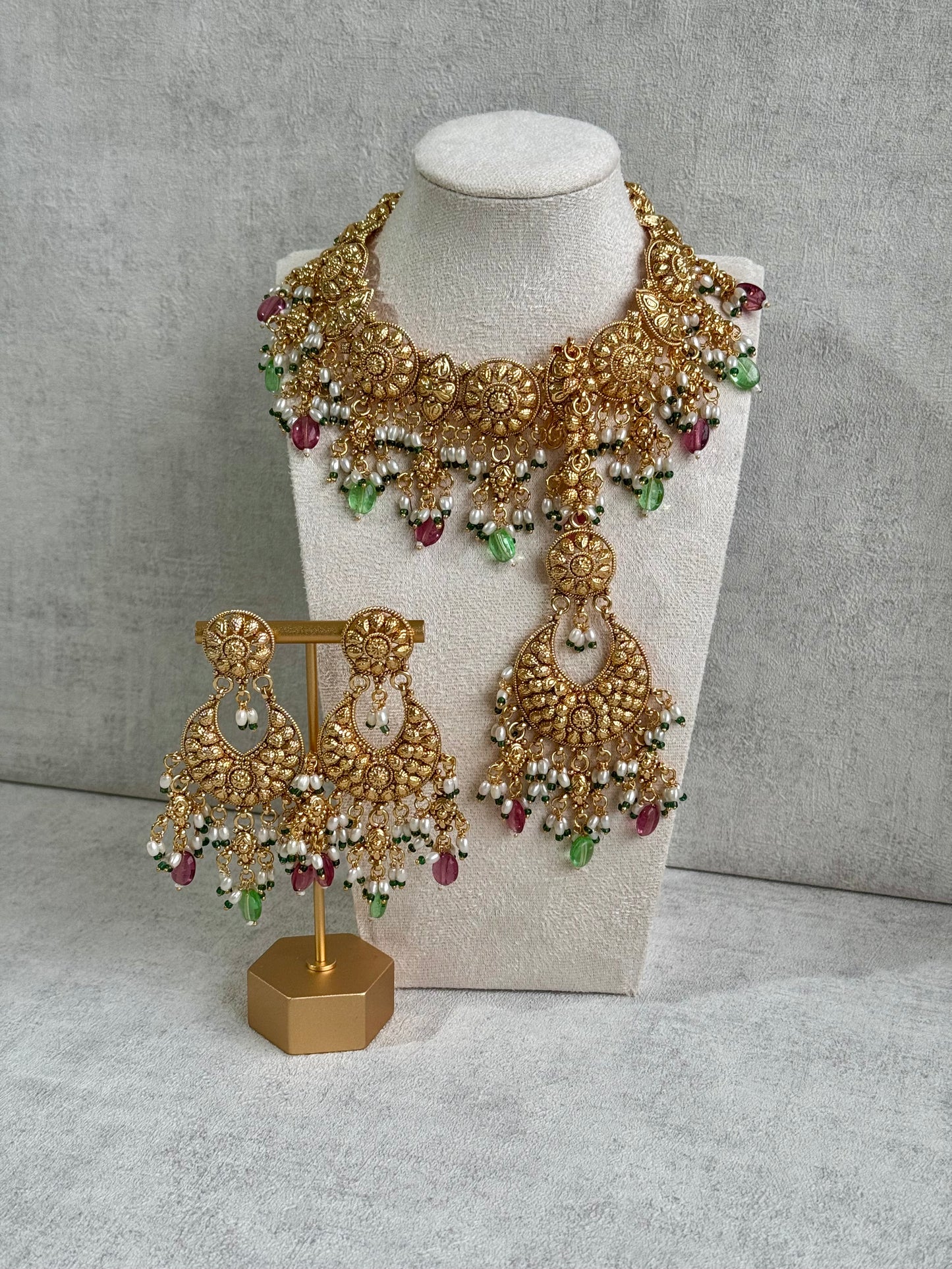 Ayura Designs Rummy Set – Opulent Gold Adornment with Radiant Pink, Green & White Beads | Includes Earrings & Tikka