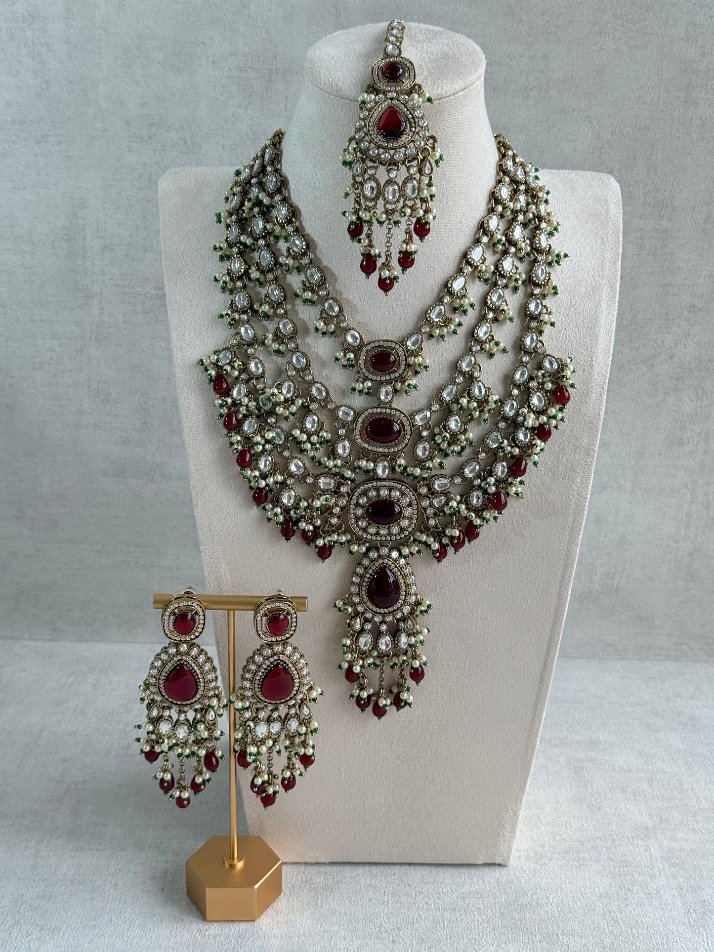 Ayura Designs Sahra Bridal Set with Earrings & Tikka – Ruby Red, Kundan Stones, Pearls & Emerald Green Accents in Antique Gold Finish