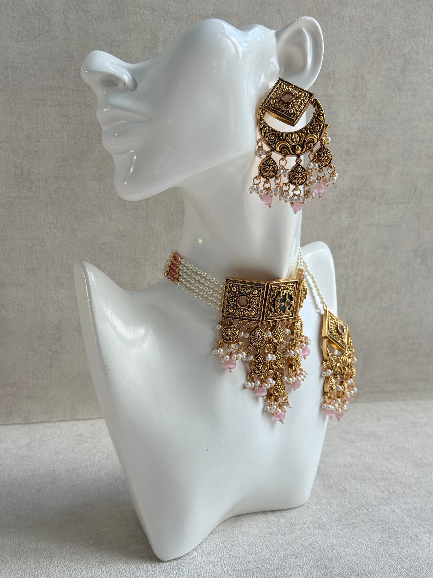 Ayura Designs Samera Choker Set with Earrings & Tikka – Blush Pink Beads, Pearl Detailing, Green Centre Stone, Floral Motifs & Antique Gold Finish