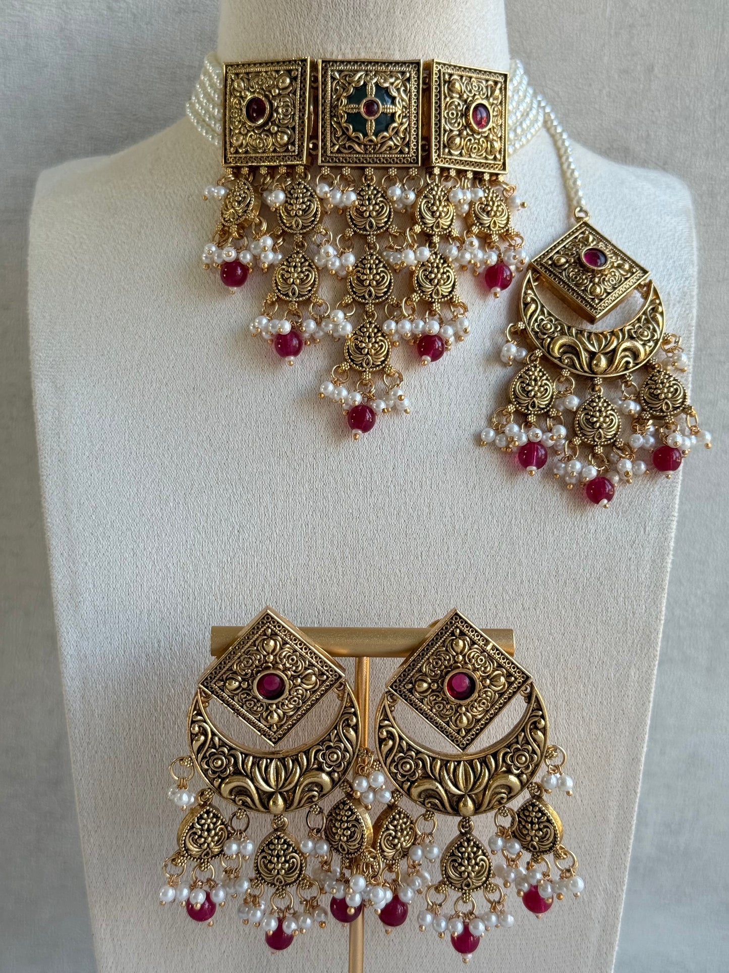 Ayura Designs Samera Choker Set with Earrings & Tikka – Rani Pink Beads, Pearl Detailing, Green Centre Stone, Floral Motifs & Antique Gold Finish
