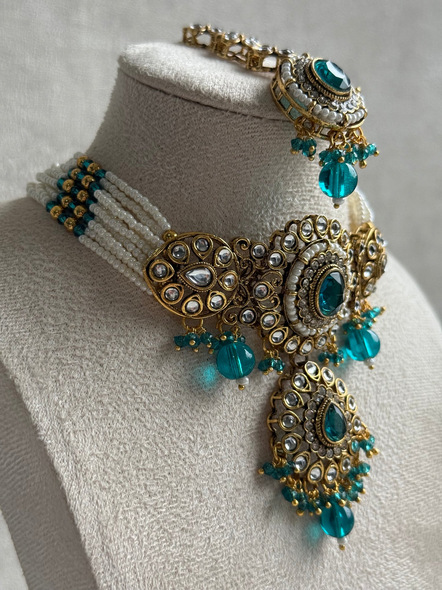 Ayura Designs Muskaan Set – Choker, Jhumkis & Tikka with Peacock Blue Beads, Kundan Stones & Antique Gold Finish