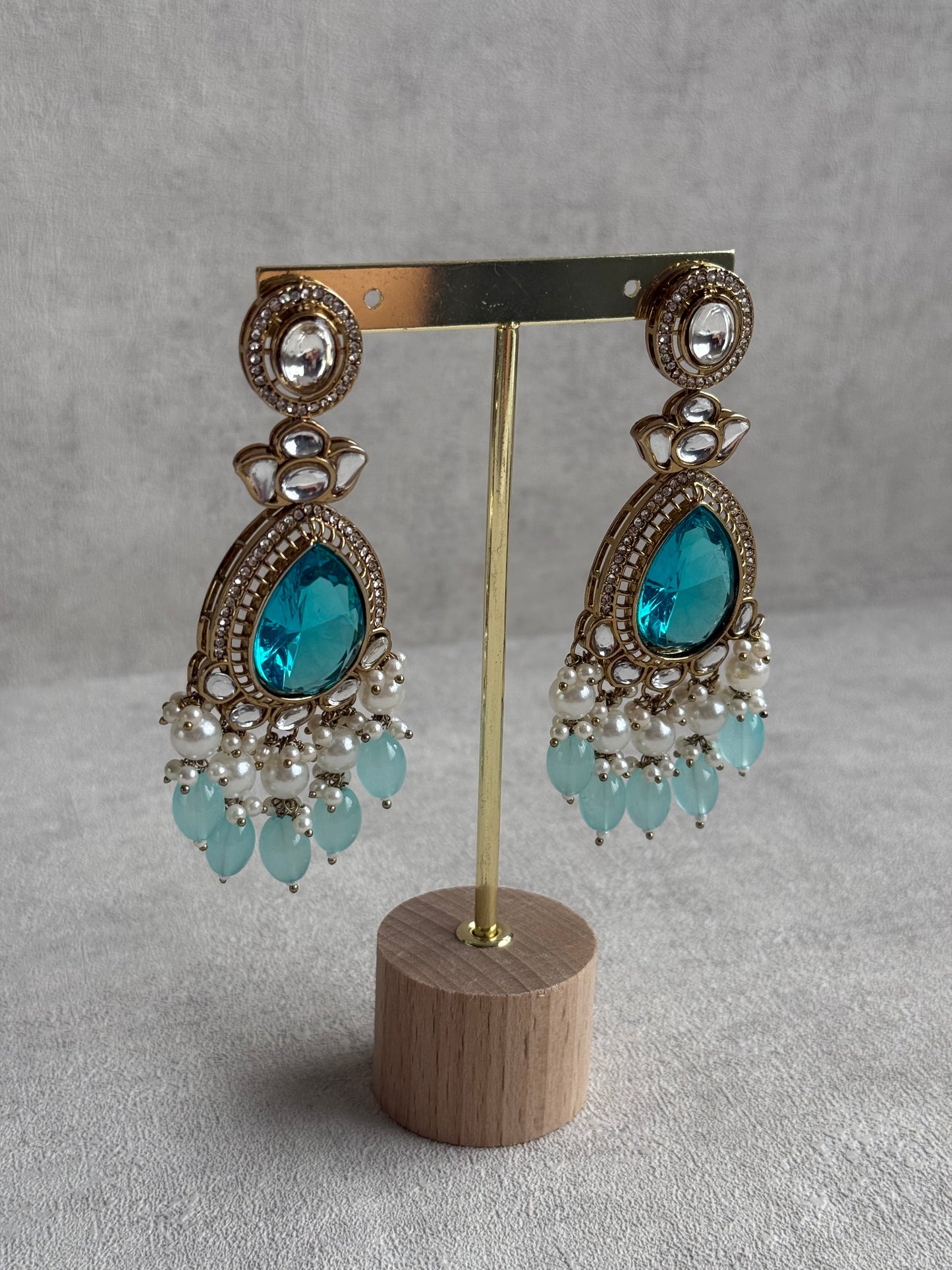 Ayura Designs Nageen Earrings – Antique Gold Jhumkis with Aqua Blue Stones, Mirror-Cut Accents & Pearl Drops