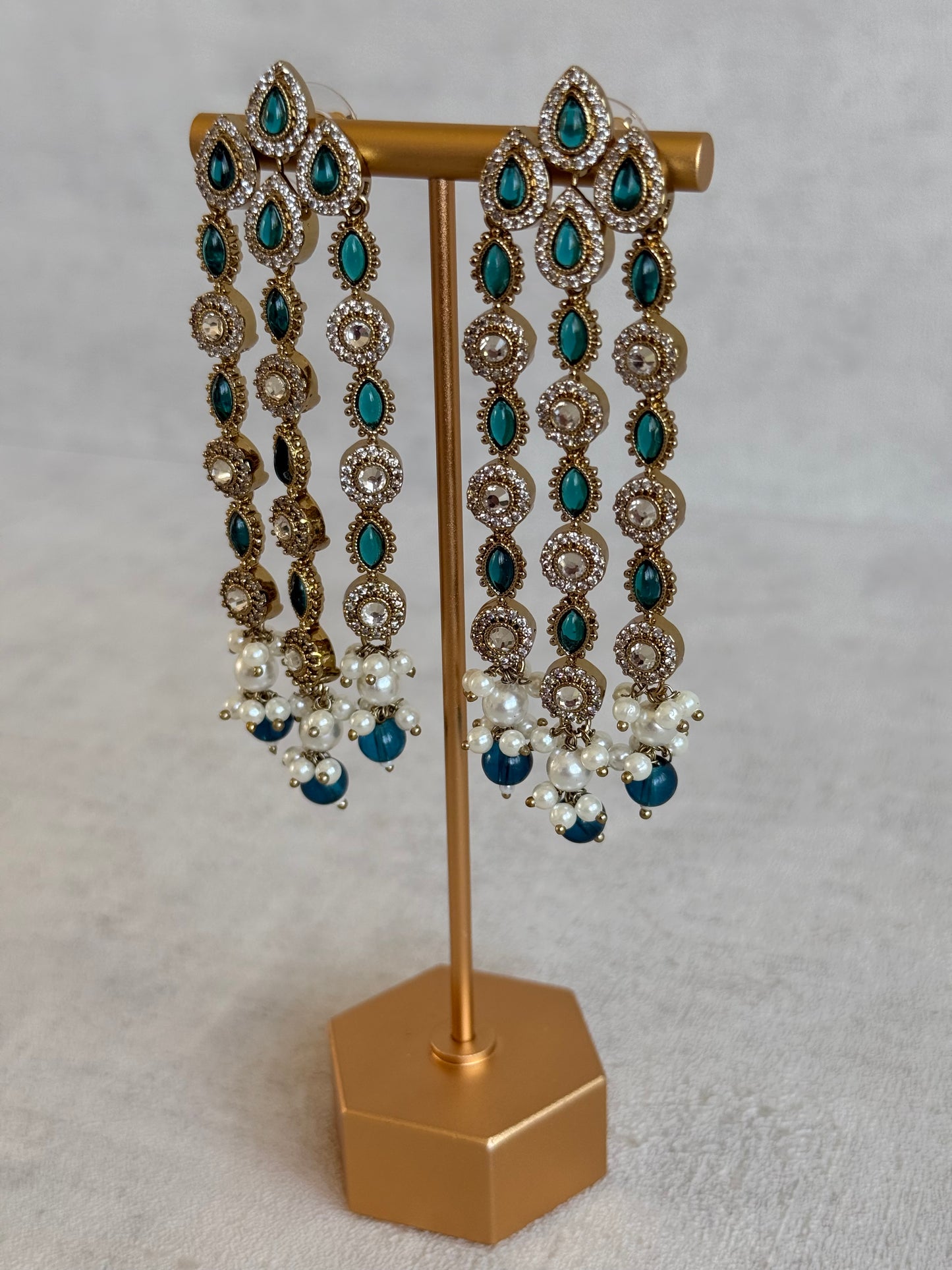 Ayura Designs Emilia Earrings – Gold Triple Strand Statement Earrings with Peacock Blue Stones & Pearl Drops