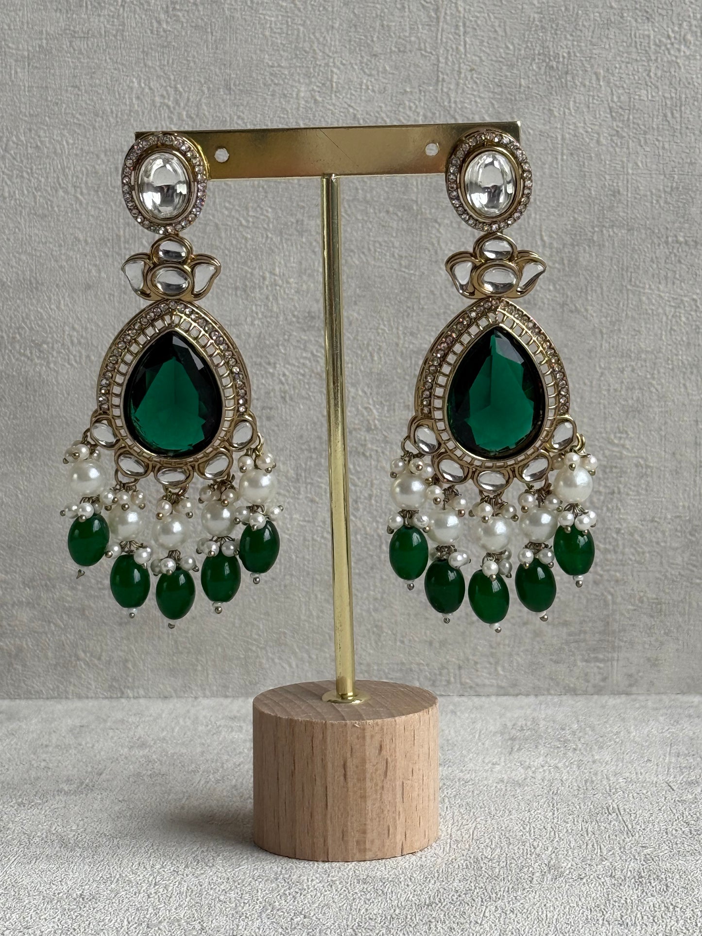 Ayura Designs Nageen Earrings – Antique Gold Jhumkis with Emerald Green Stones, Mirror-Cut Accents & Pearl Drops