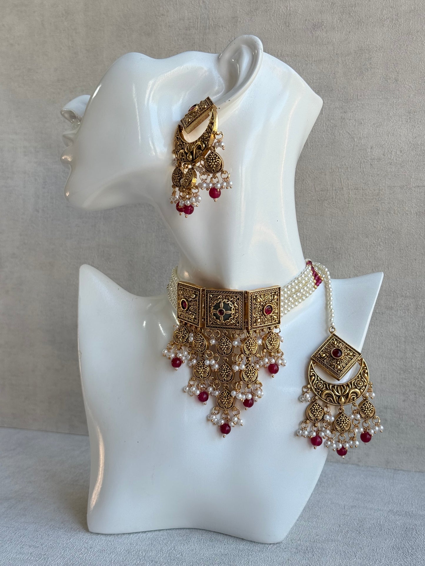 Ayura Designs Samera Choker Set with Earrings & Tikka – Rani Pink Beads, Pearl Detailing, Green Centre Stone, Floral Motifs & Antique Gold Finish