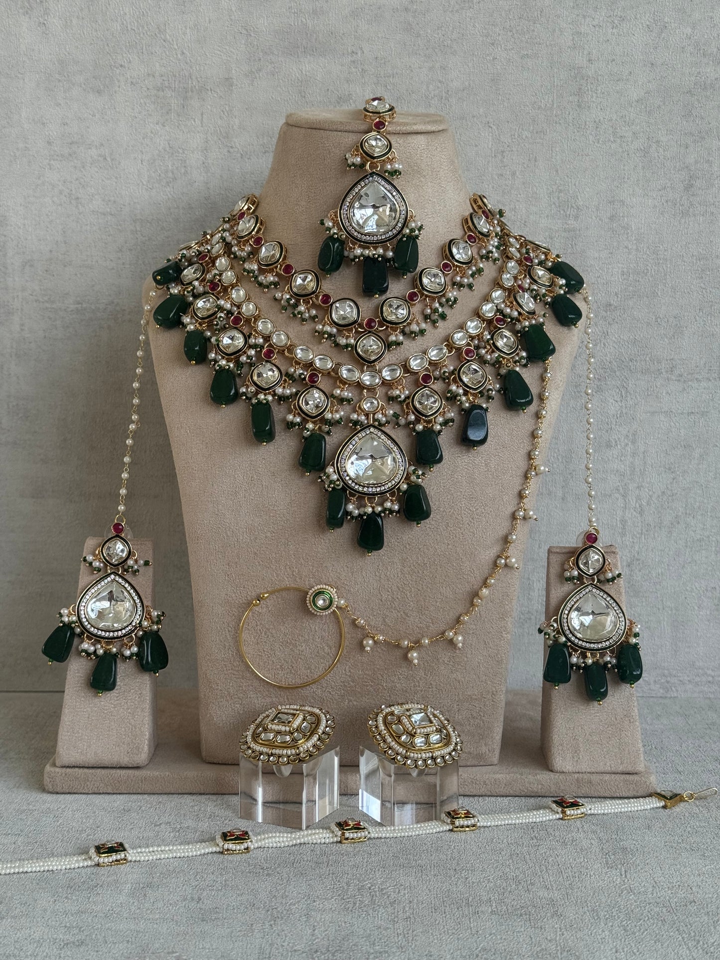 Ayura Designs Malika Bridal Set with Necklace, Jhumkis, Tikka, Nath, Ring & Sheeshphool – Jadau Kundan Craftsmanship with Mirror-Cut Polki, Emerald Green Drops, Ruby Accents & Antique Gold Finish