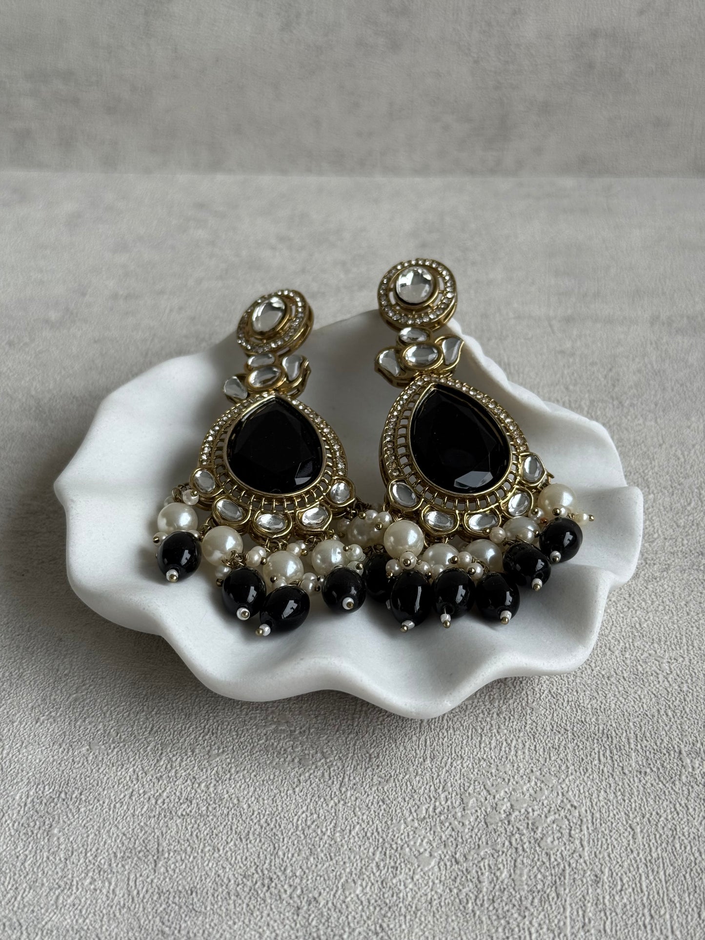 Ayura Designs Nageen Earrings – Antique Gold Jhumkis with Black Stones, Mirror-Cut Accents & Pearl Drops