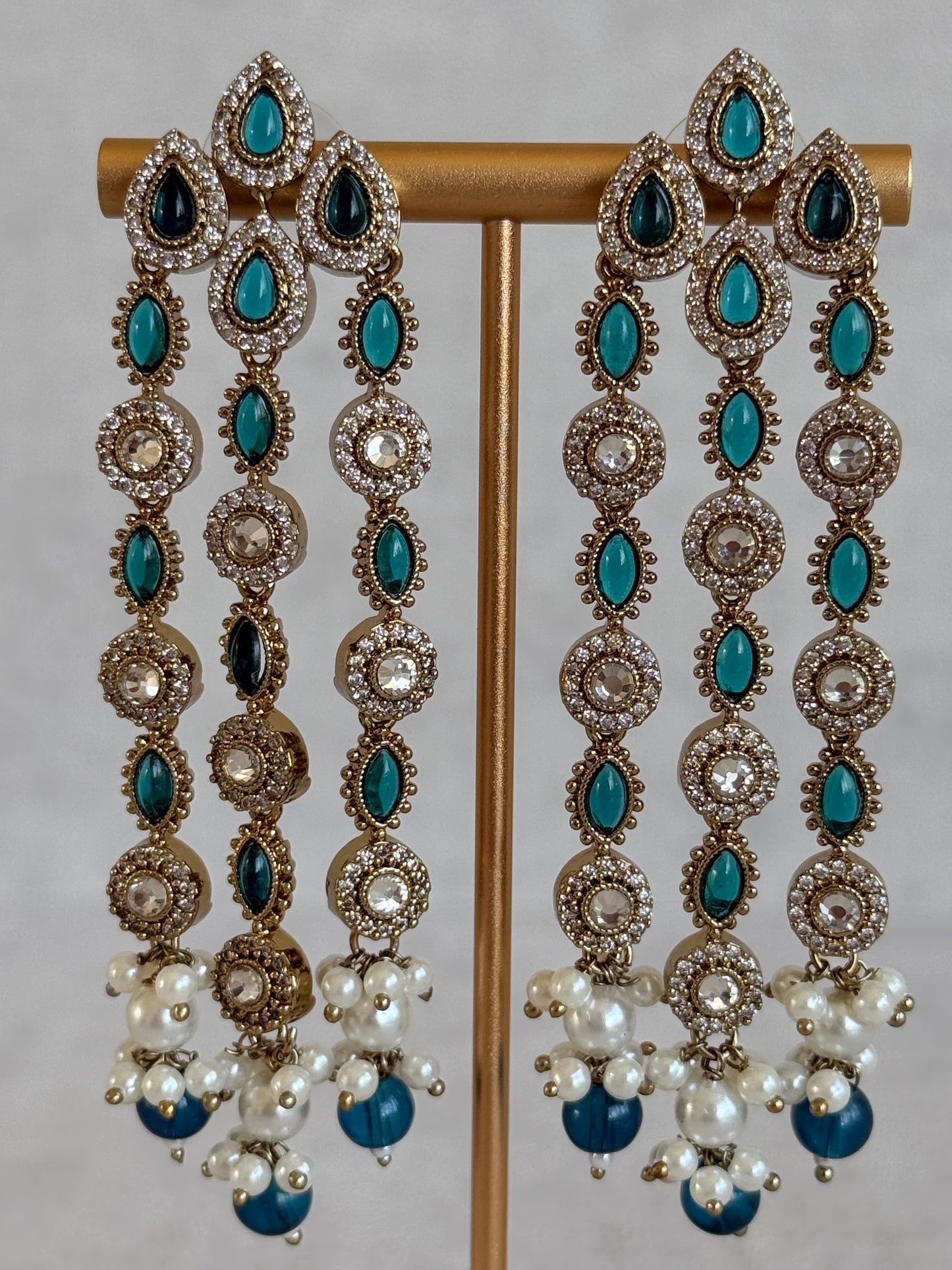 Ayura Designs Emilia Earrings – Gold Triple Strand Statement Earrings with Peacock Blue Stones & Pearl Drops