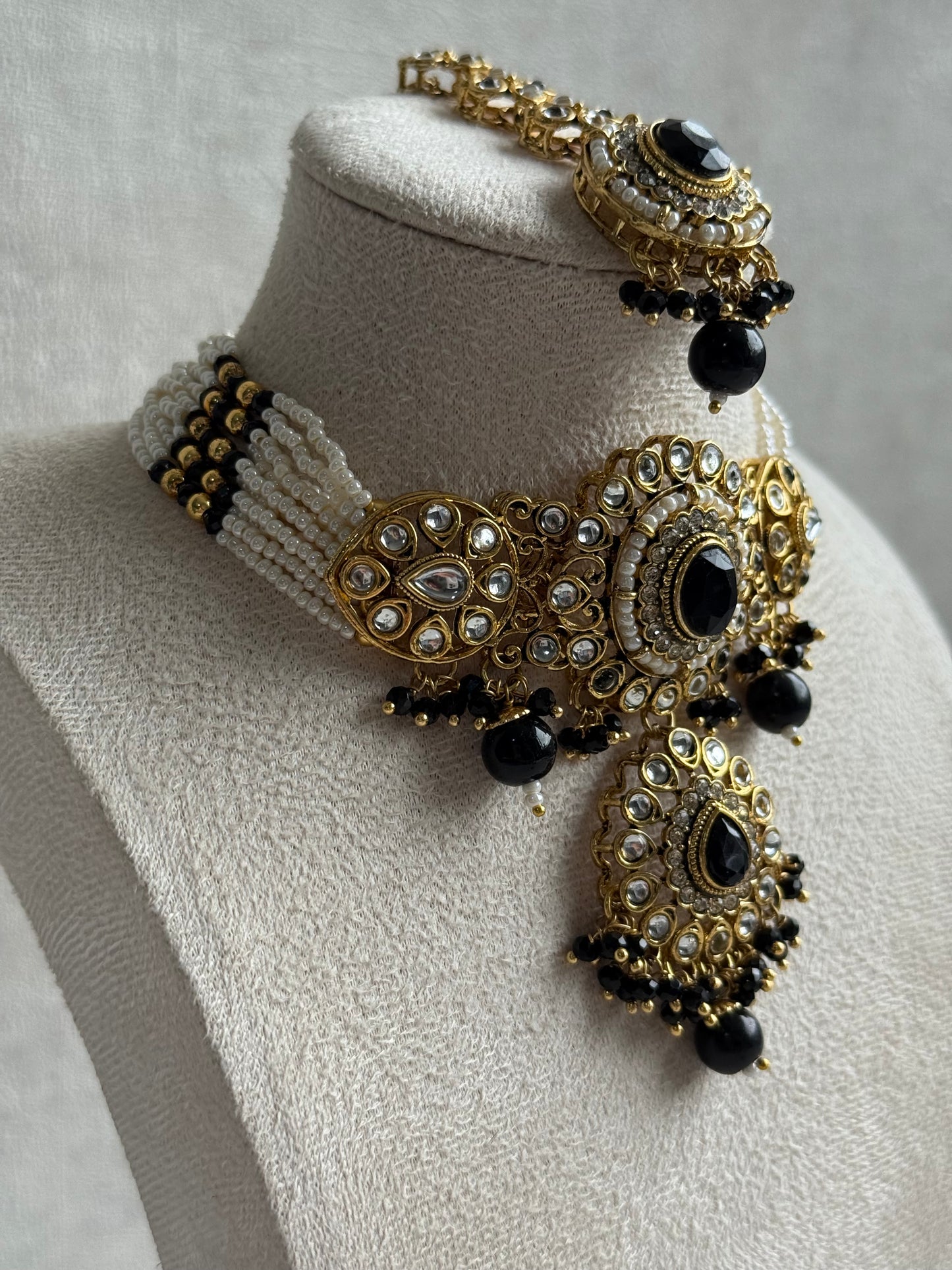 Ayura Designs Muskaan Set – Choker, Jhumkis & Tikka with Black Beads, Kundan Stones & Antique Gold Finish