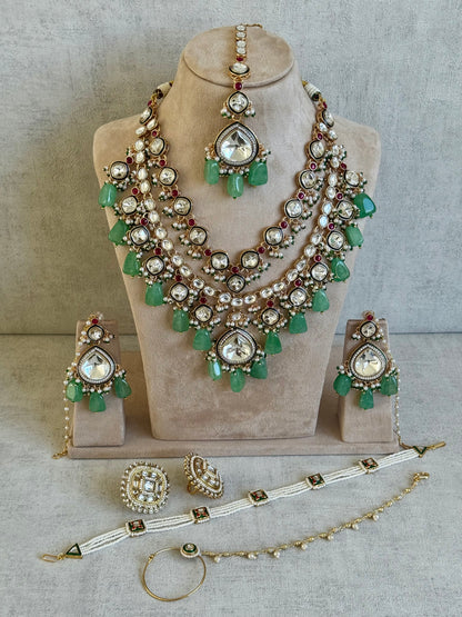 Ayura Designs Malika Bridal Set with Necklace, Jhumkis, Tikka, Nath, Ring & Sheeshphool – Jadau Kundan Craftsmanship with Mirror-Cut Polki, Jade-Toned Drops, Ruby Accents & Antique Gold Finish