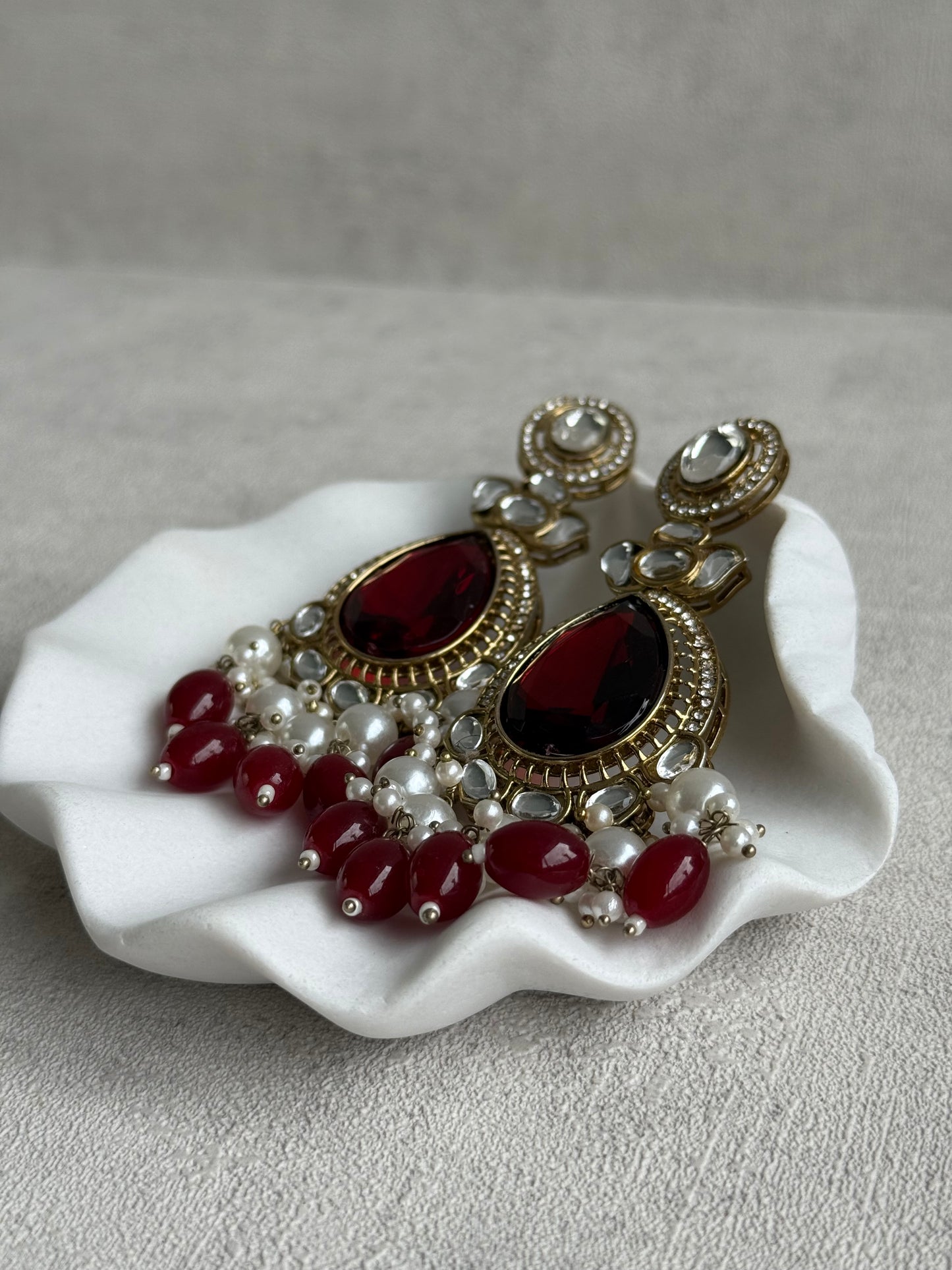 Ayura Designs Nageen Earrings – Antique Gold Jhumkis with Ruby Red Stones, Mirror-Cut Accents & Pearl Drops