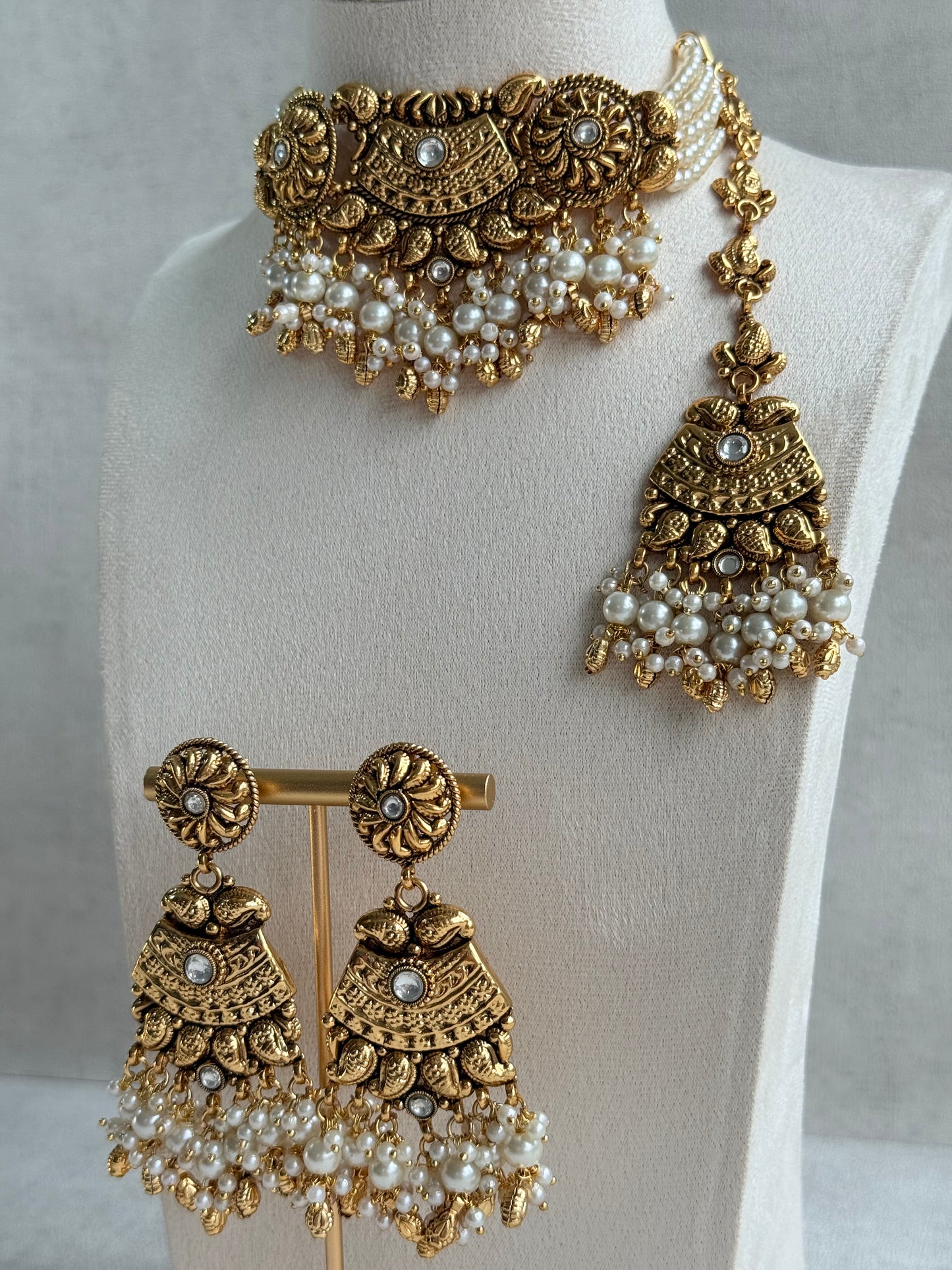 Ayura Designs Sairish Choker Set with Earrings & Tikka – Ivory Beads, Pearl Detailing, Ghungroos, Paisley Motifs & Antique Gold Finish