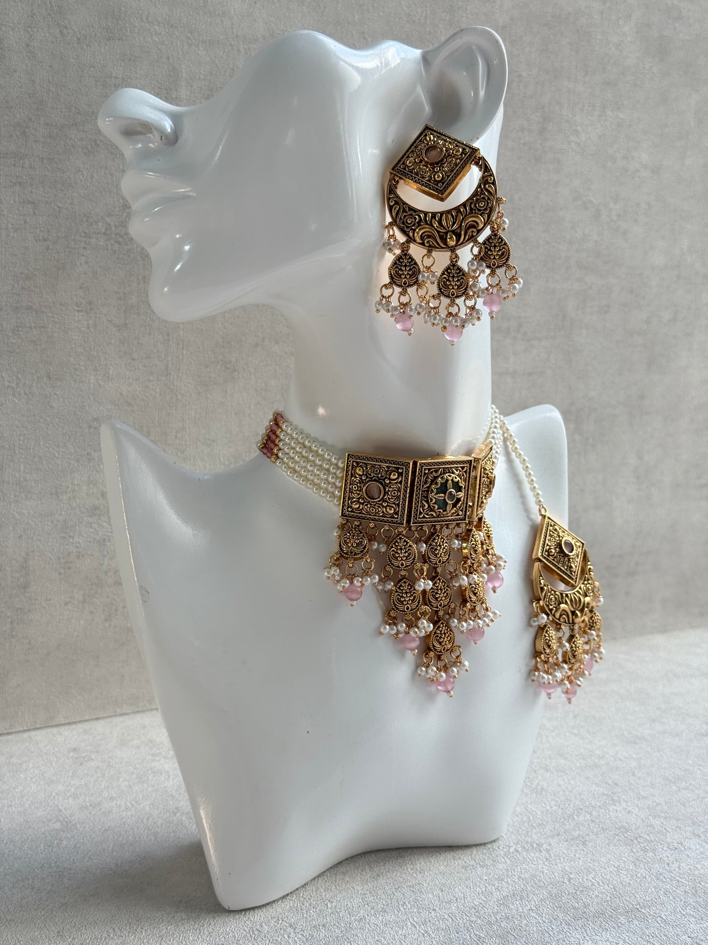Ayura Designs Samera Choker Set with Earrings & Tikka – Blush Pink Beads, Pearl Detailing, Green Centre Stone, Floral Motifs & Antique Gold Finish