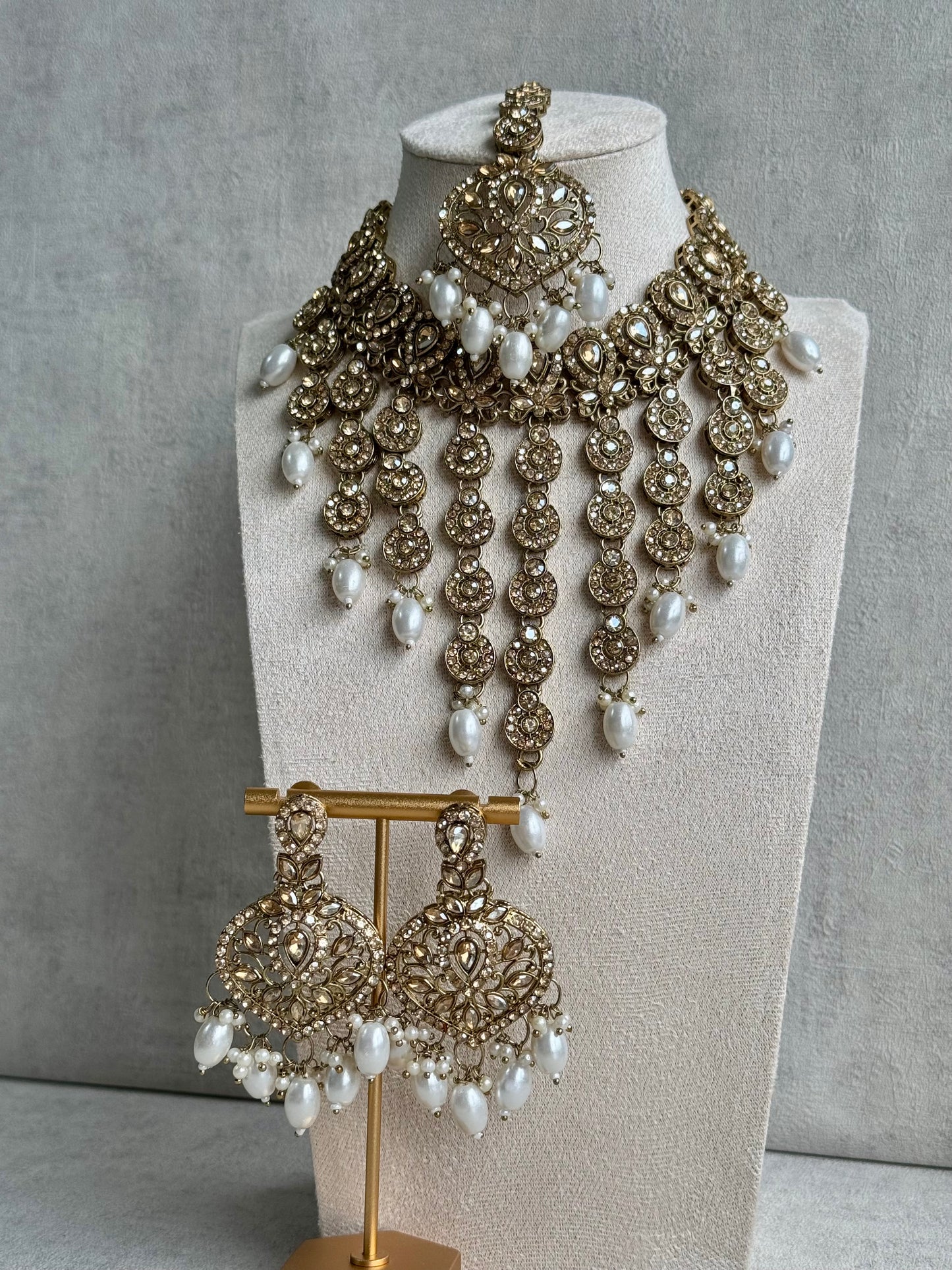 Ayura Designs Sameena Set – Opulent Champagne Gold Adorned with Luminous White Pearls Featuring a Statement Necklace, Tikka, and Chandelier Earrings