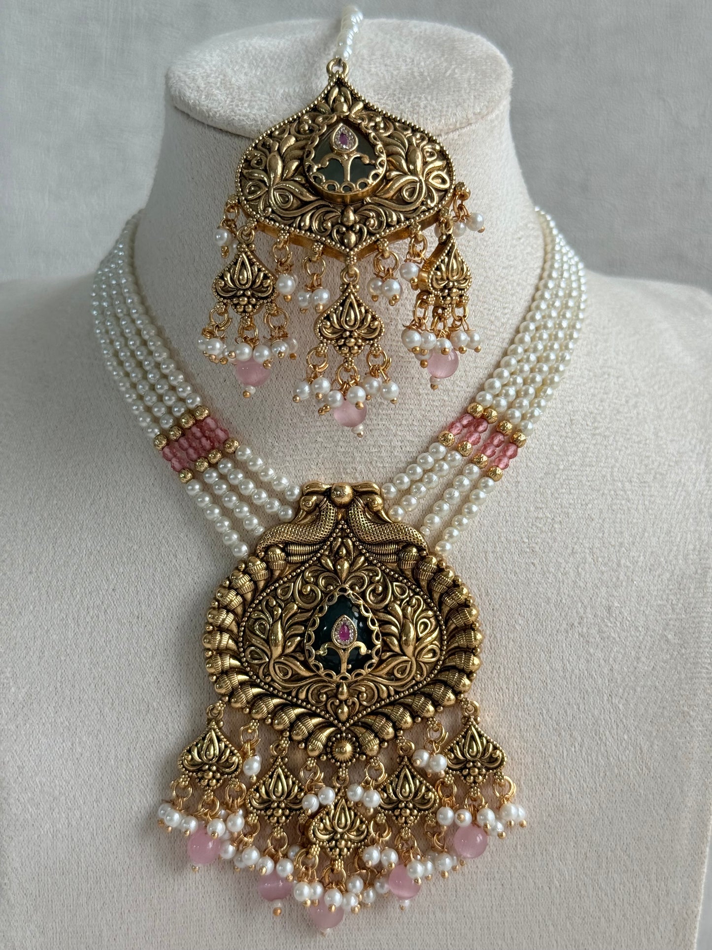 Ayura Designs Afia Necklace Set with Earrings & Tikka – Antique Gold, Blush Pink Pearls, Green Centre Stone & Peacock Motifs