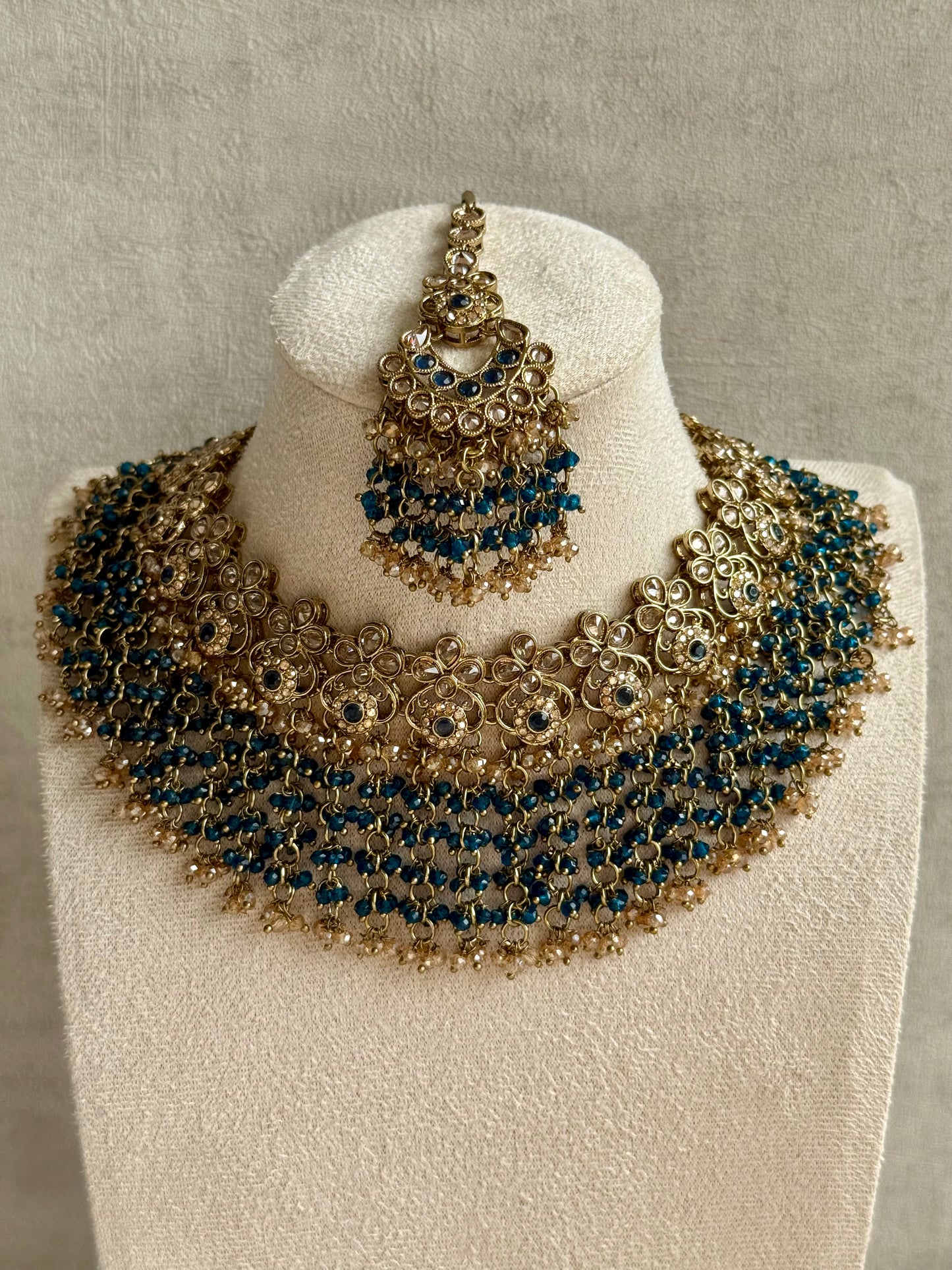 Ayura Designs Mahreen Set – Necklace, Jhumkis & Tikka with Mirror-Cut Stones, Peacock Blue Beads & Gold Finish