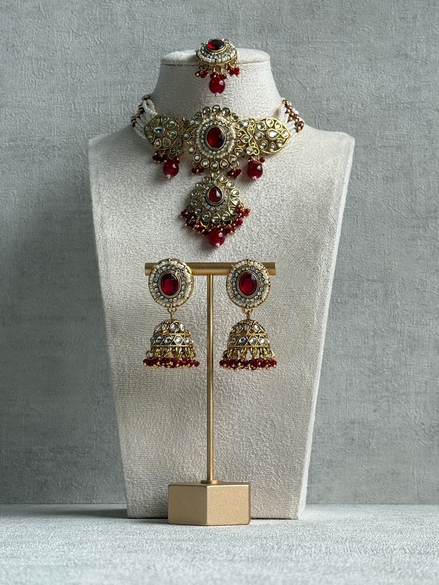 Ayura Designs Muskaan Set – Choker, Jhumkis & Tikka with Ruby Red Beads, Kundan Stones & Antique Gold Finish