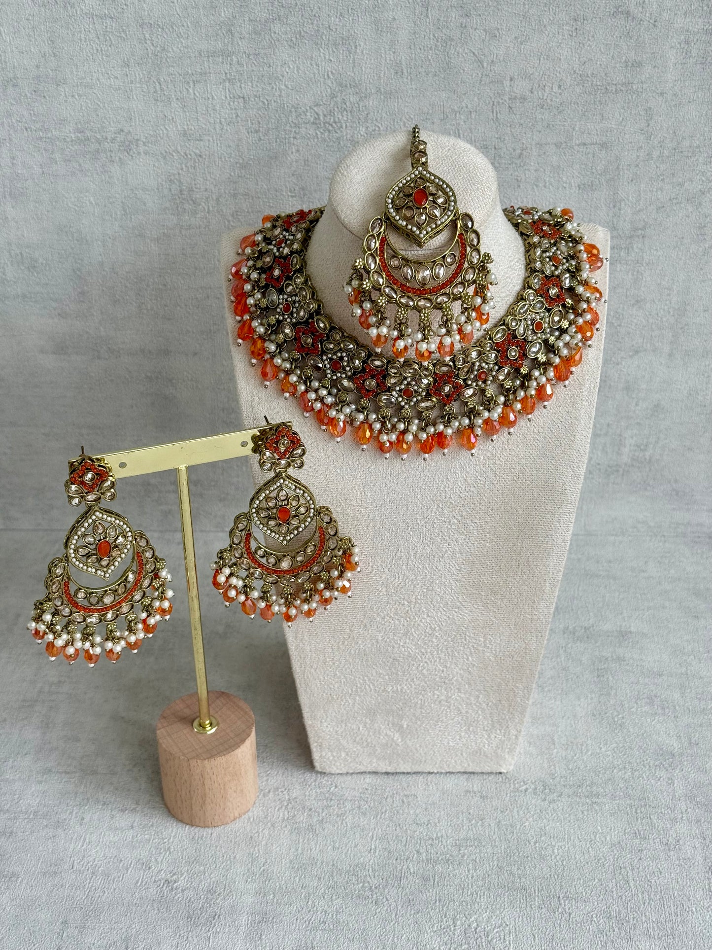 Ayura Designs Jazba Set with Necklace, Jhumkis & Tikka – Antique Gold, Mirror-Cut Stones, Pearl Detailing & Fiery Orange Beads
