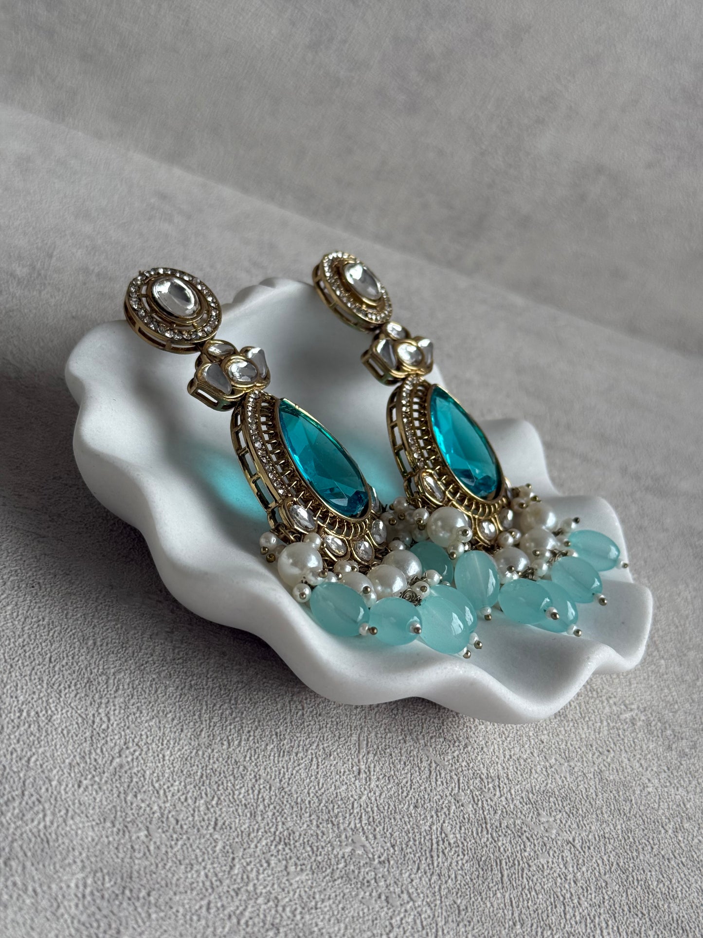 Ayura Designs Nageen Earrings – Antique Gold Jhumkis with Aqua Blue Stones, Mirror-Cut Accents & Pearl Drops
