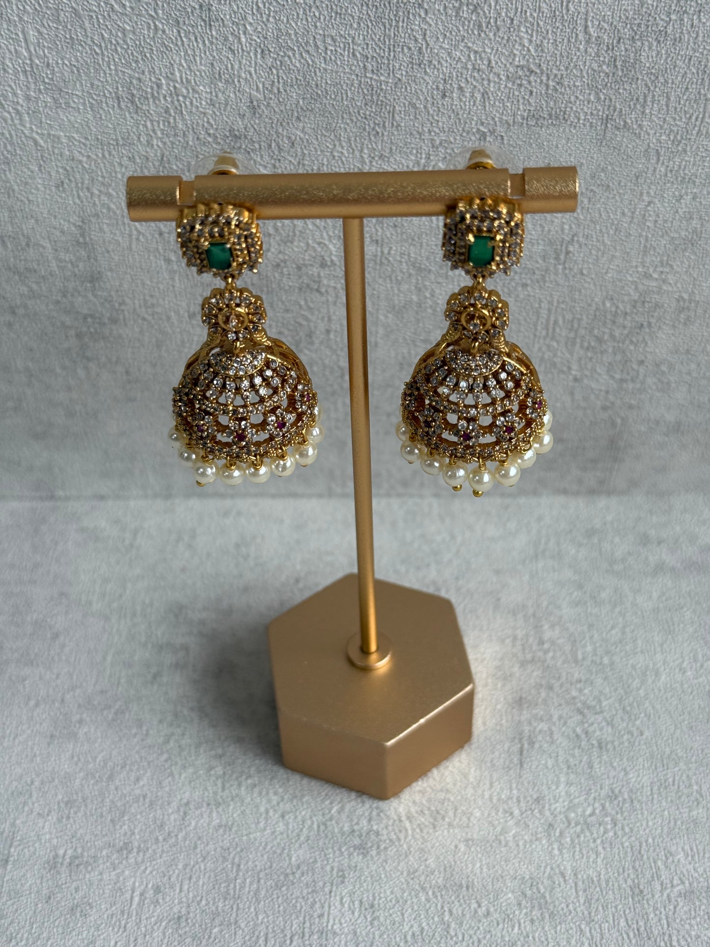 Ayura Designs Maya Jhumkis – Gold Jhumkis with Emerald Green Studs, Pink Stones, Crystal Detailing & Pearl Drops