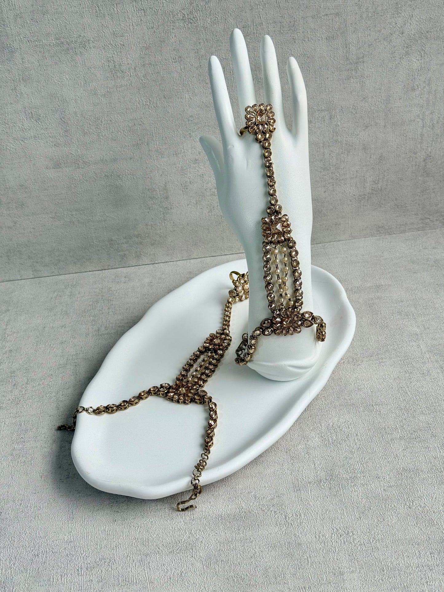 Ayura Designs Rupi Haathphool – Antique Gold with Champagne Stones & Pearl Detailing