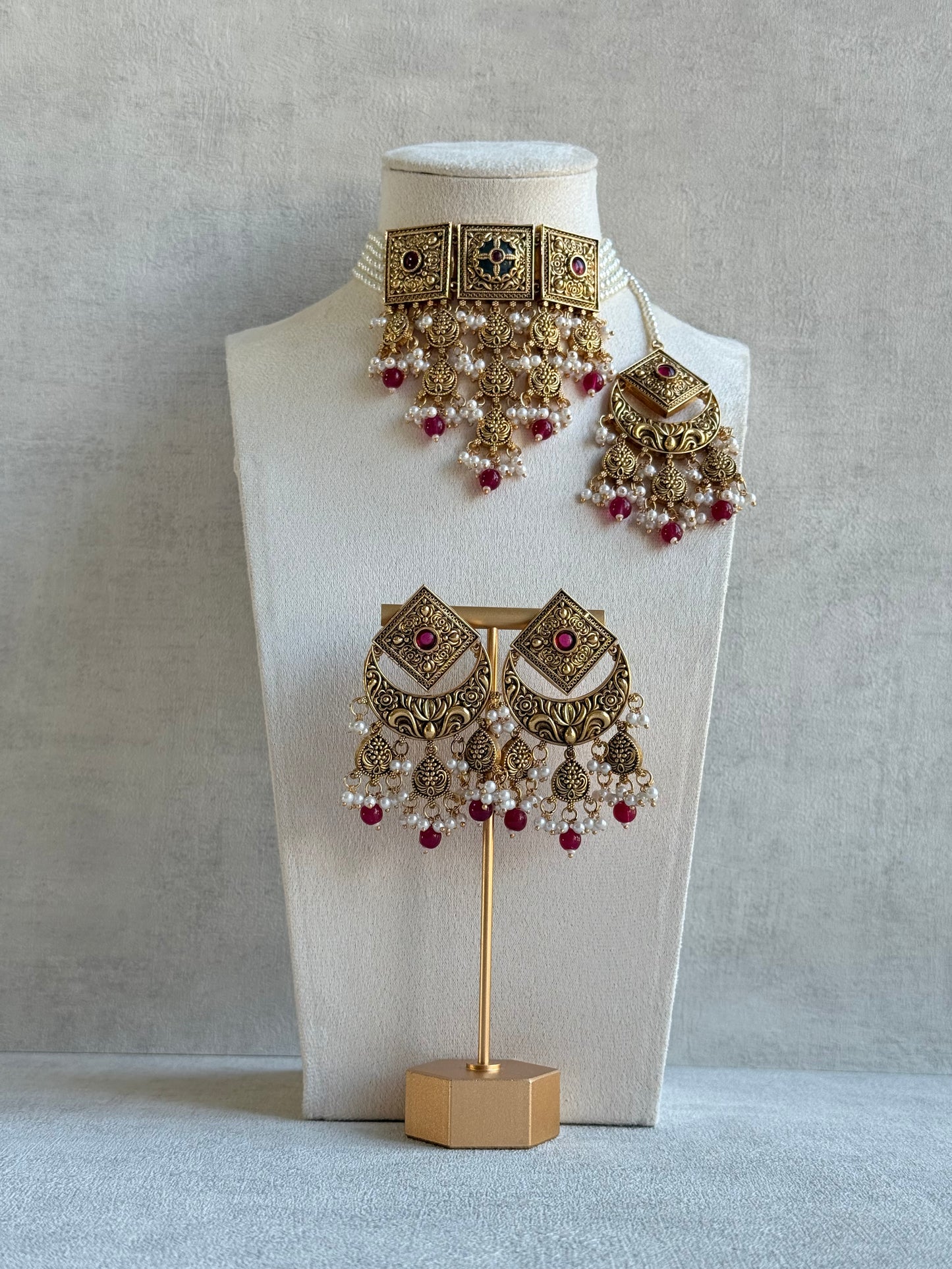 Ayura Designs Samera Choker Set with Earrings & Tikka – Rani Pink Beads, Pearl Detailing, Green Centre Stone, Floral Motifs & Antique Gold Finish