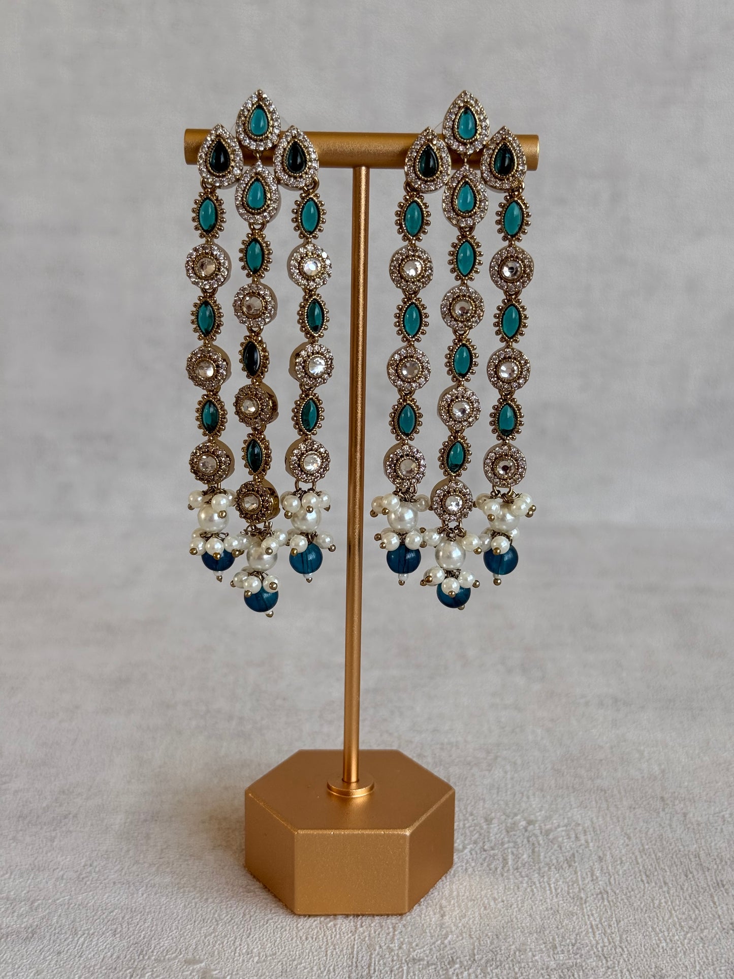 Ayura Designs Emilia Earrings – Gold Triple Strand Statement Earrings with Peacock Blue Stones & Pearl Drops