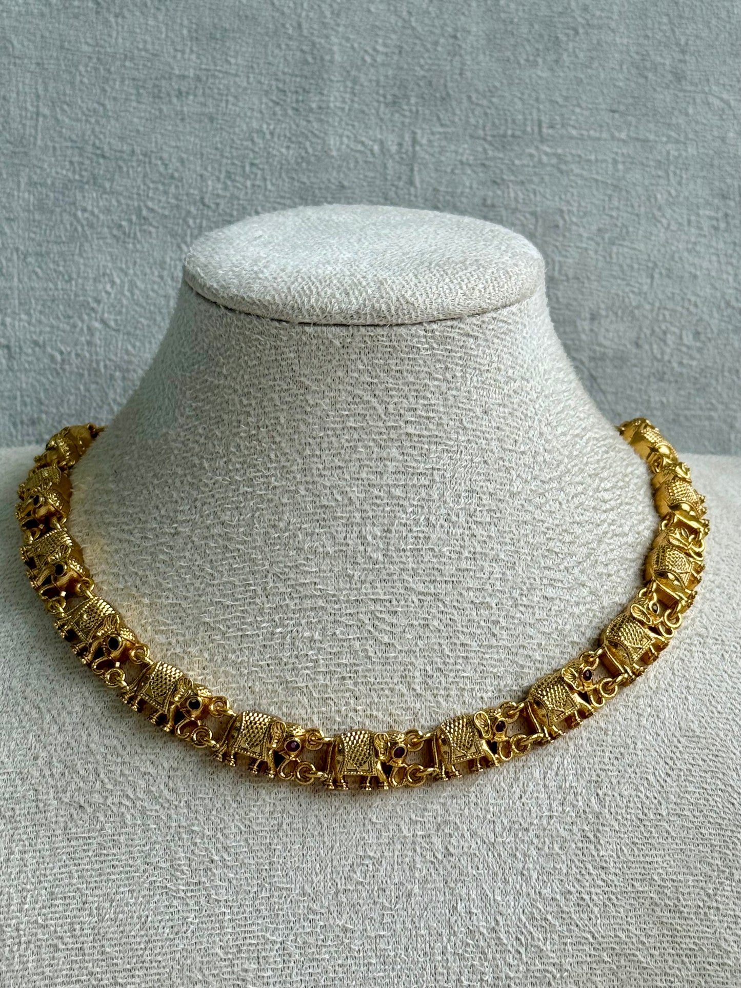 Ayura Designs Veda Set – Antique Gold Necklace & Stud Earrings with Elephant Motifs and Pink Stone Detailing